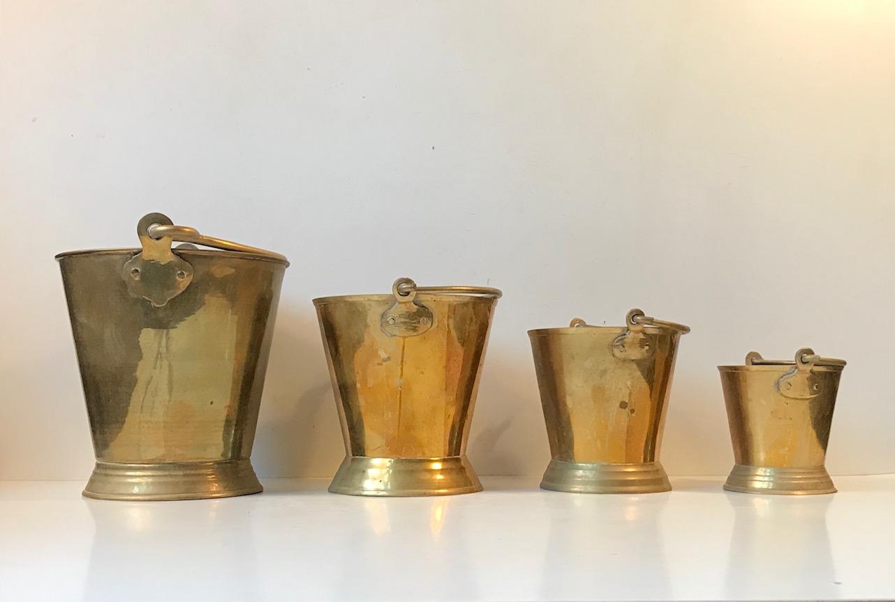 Indian brass buckets in 4 different sizes. Use them as barware, for nautical/maritime utility, as planters or vases. Manufactured in India during the 1960s. The price is for the set.