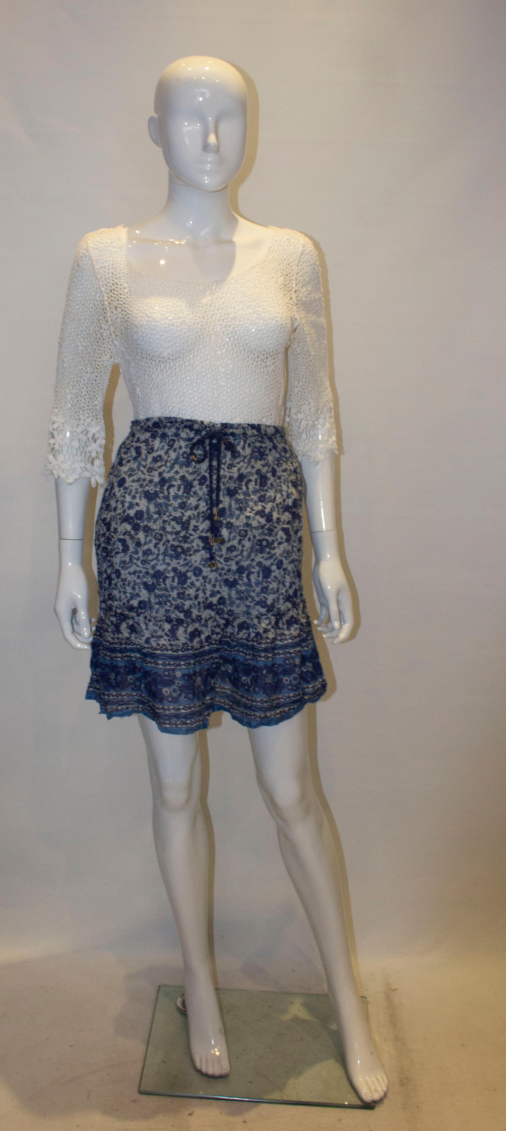A pretty vintage Indian cotton skirt in shades of blue. The skirt is fully  lined , has a frill at the hem and a drawstring waist. Measurements , waist 25'' - 28'', length 20''.