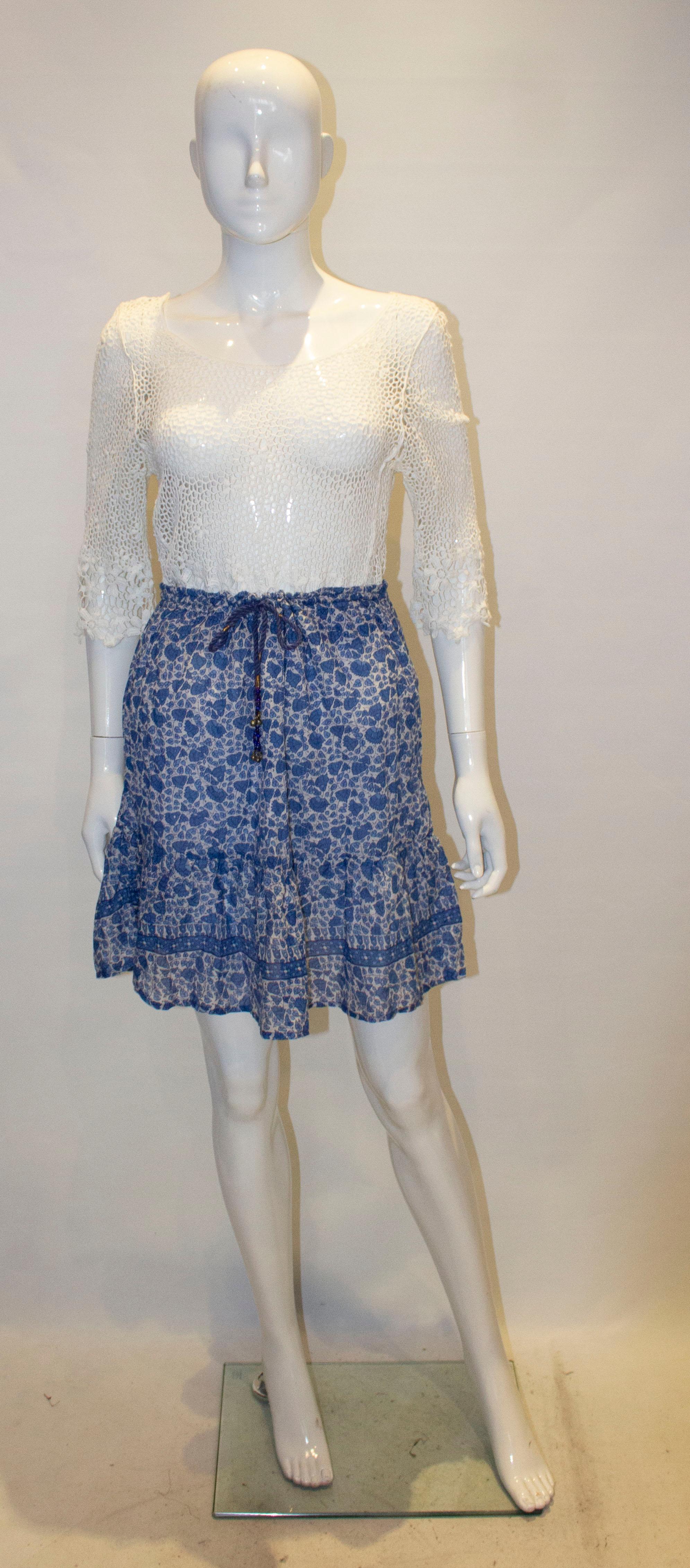 A pretty vintage boho  skirt for Summer in Indian cotton. The skirt is in a pretty blue print with frill at the hem. it is fully lined and has a drawstring waist , fitting between waist 24'' -29''