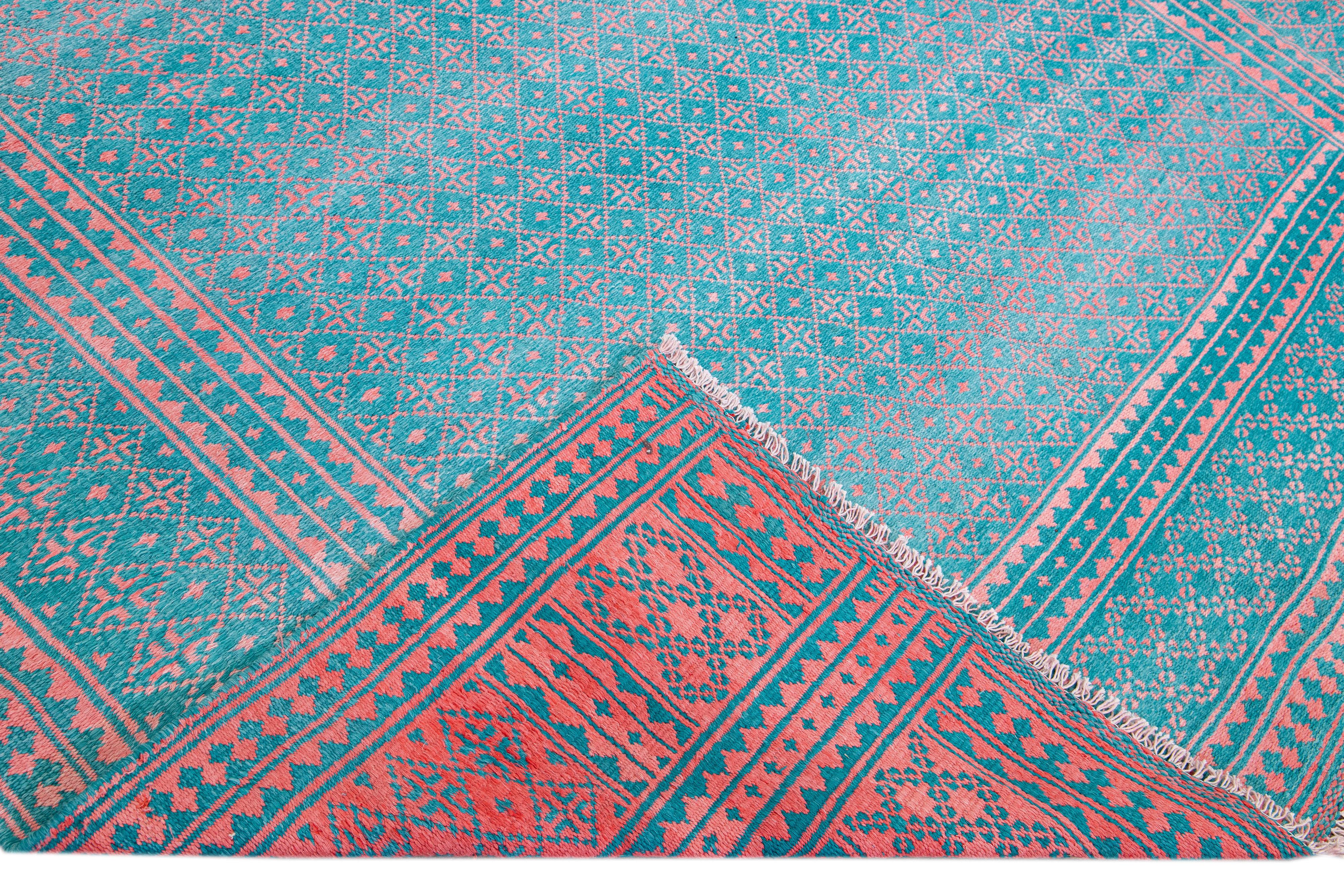 Beautiful Vintage Indian hand-knotted wool and cotton rug with a turquoise field. This vintage rug has pink accents in a gorgeous all-over geometric design.

This rug measures: 8'3