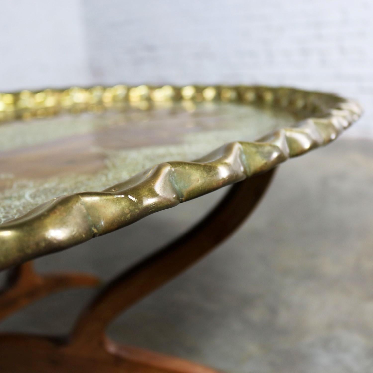 Handsome vintage Moroccan style oval brass tray coffee table on 4 spider legs made in India. This rather campaign style coffee table is in fabulous vintage condition with a gorgeous patina, including scratches and spotting, that only comes with age
