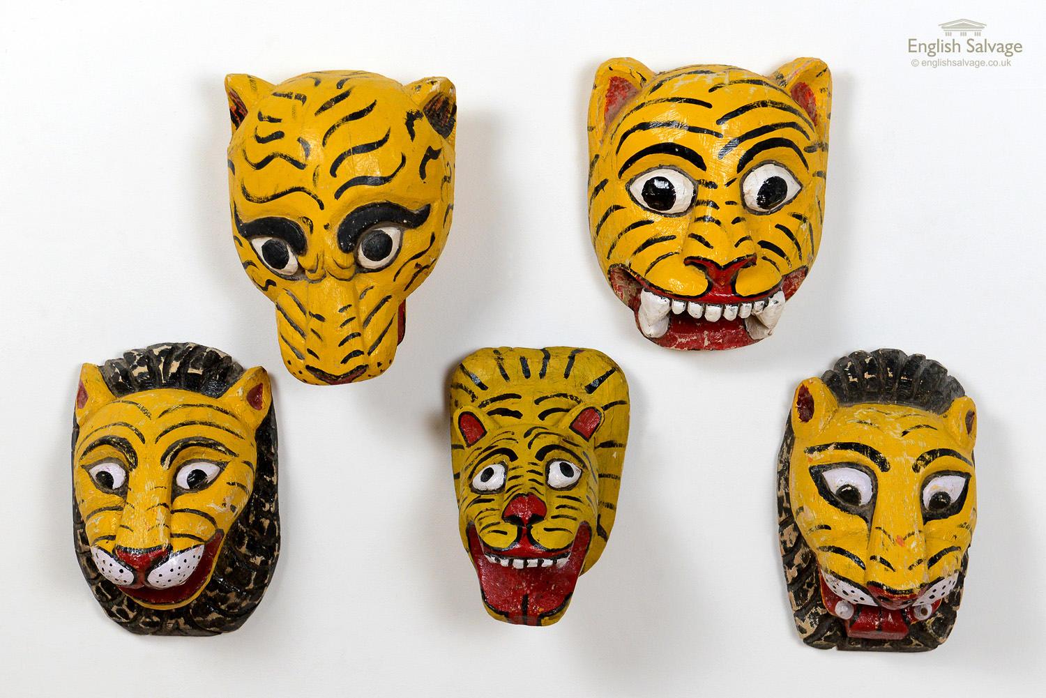 Characterful vintage Indian painted tiger masks which would make great wall displays. The top left tiger is 23cm wide x 32cm high x 18cm deep. The top right tiger is 26cm wide x 33cm high x 19cm high. The bottom two tigers with black manes are each