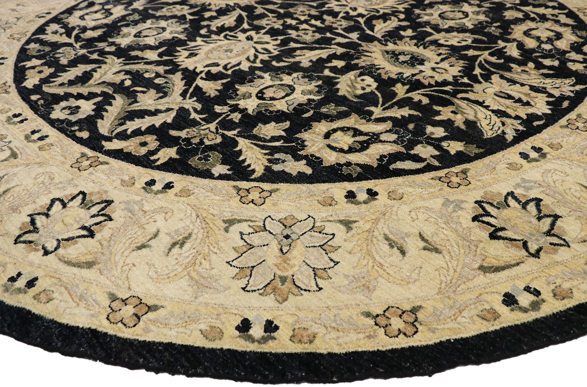 77361 Vintage Indian Round Area Rug, Circular Rug with Modern Amish Style. This vintage hand knotted wool Indian round area rug features an all-over floral pattern spread across an abrashed black field. Large harshang palmettes, serrated leaves,