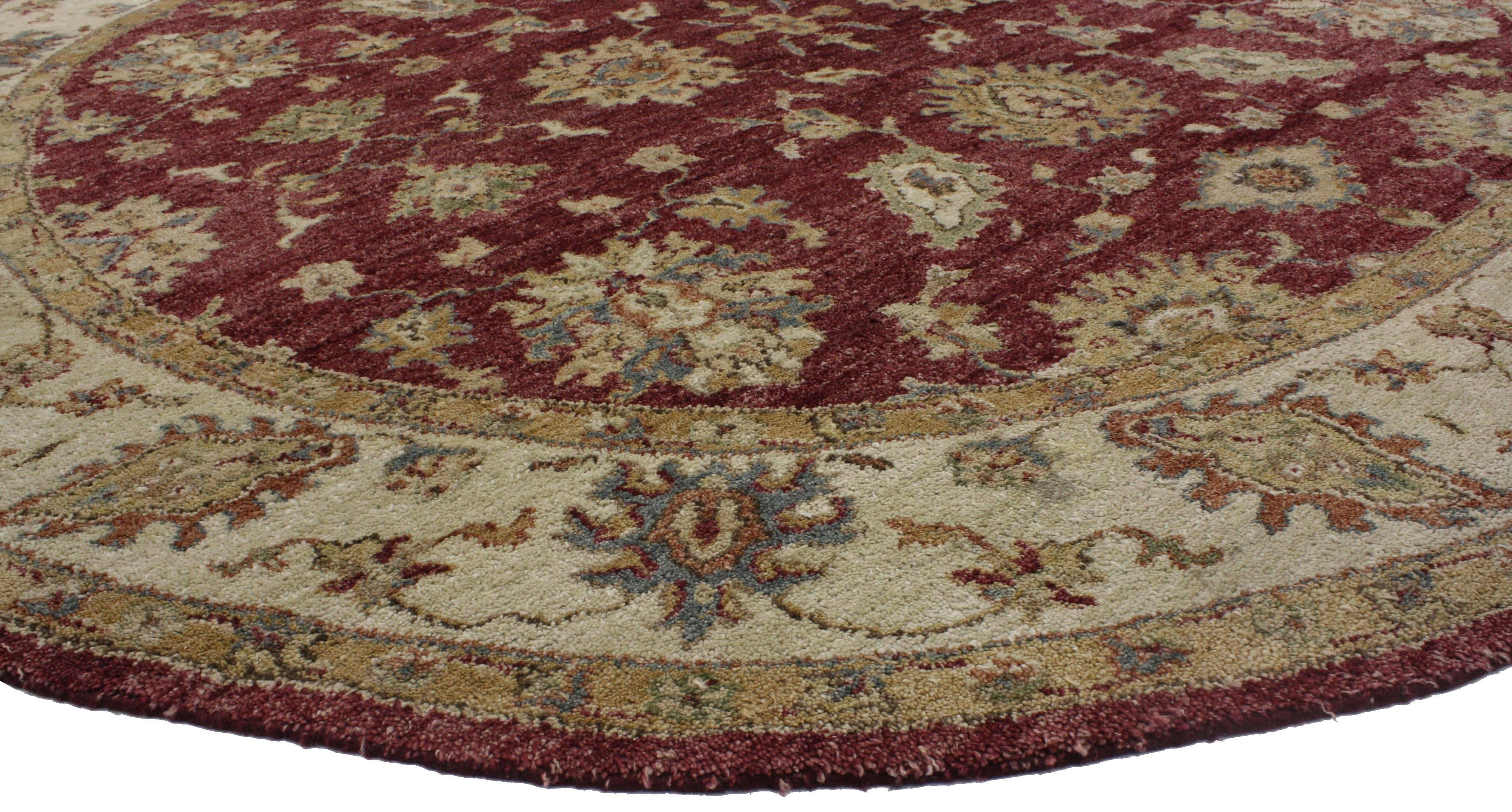 76662, vintage Indian round area rug, circular rug with Traditional Style. This vintage hand knotted wool Indian round area rug features an all-over floral pattern spread across an abrashed burgundy field. Large harshang palmettes, leafy tendrils,