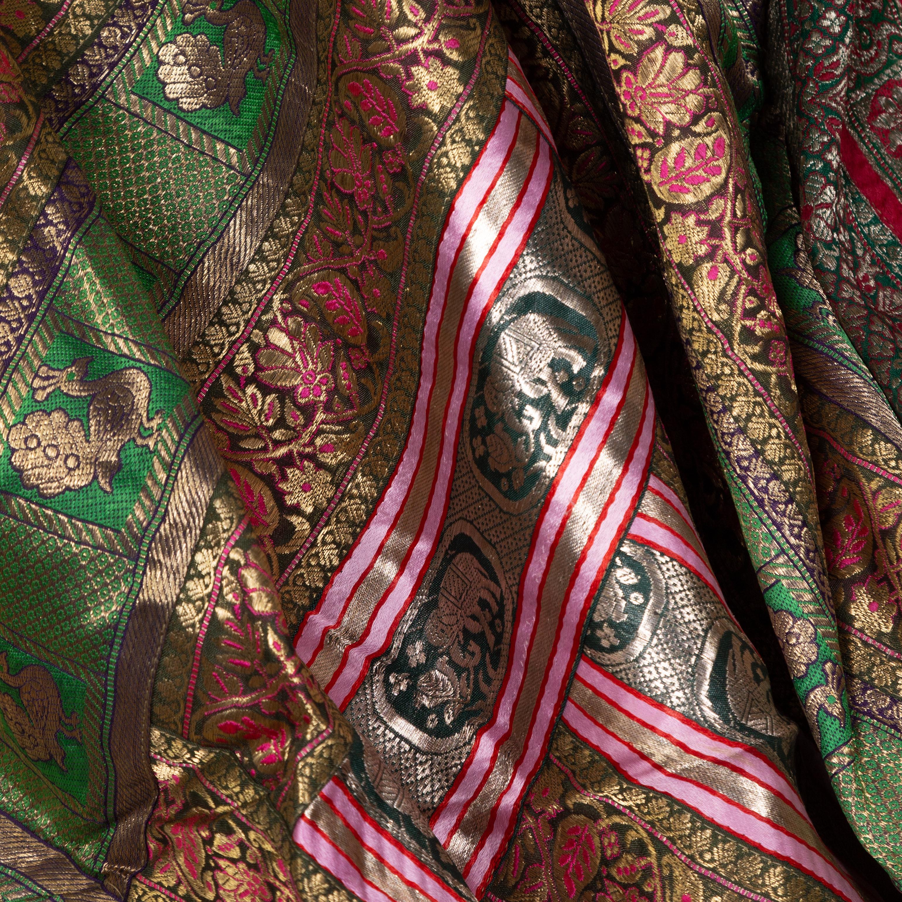 An Indian vintage large silk embroidered fabric from the second half of the 20th century with elephants, peacocks, green, red, pink, silver, fuchsia and golden tones among others. Possibly originating from Rajasthan, this stunning silk fabric is
