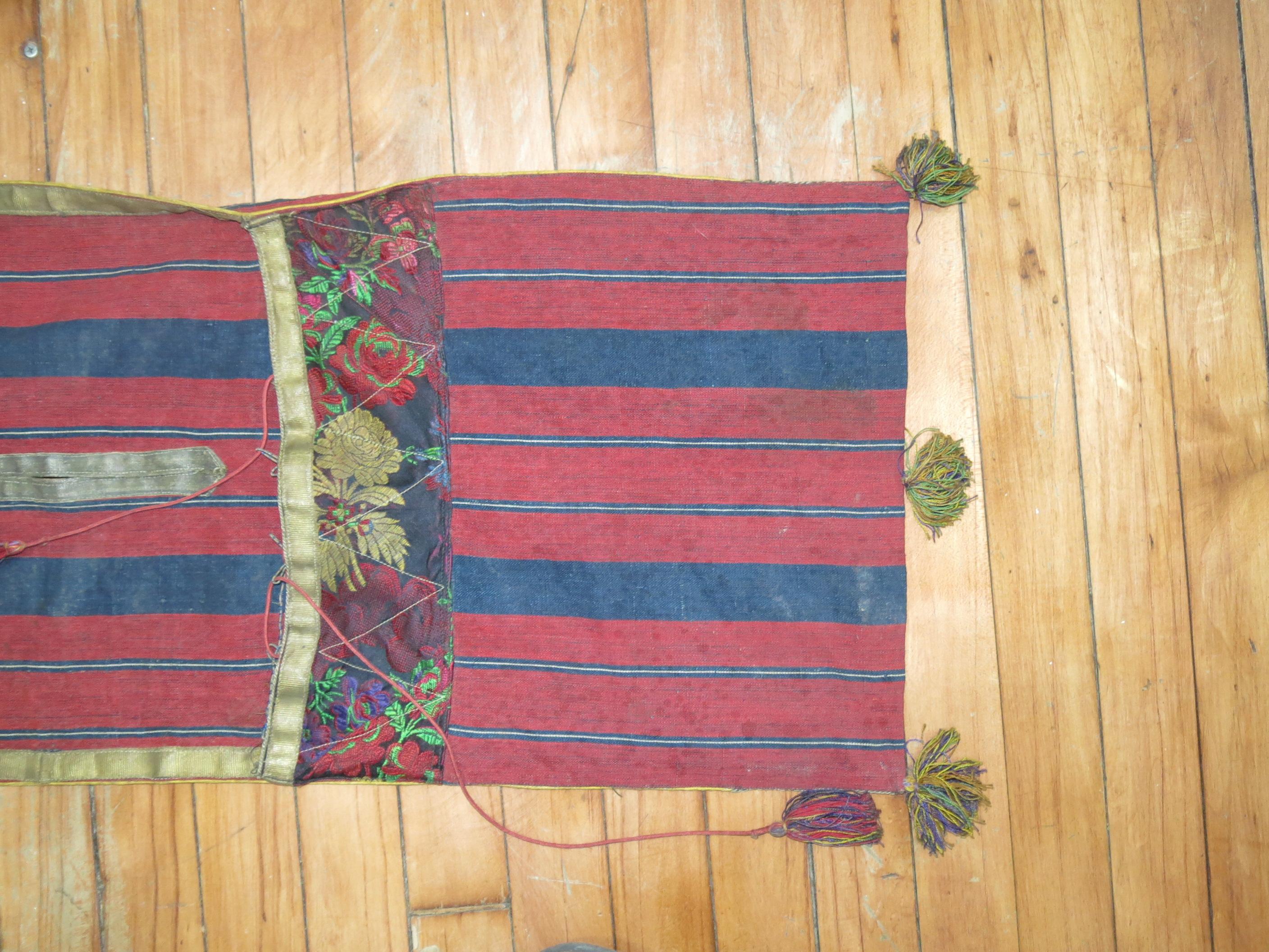 Handwoven Indian textile in reds and blues

Measures: 13'' x 37'.