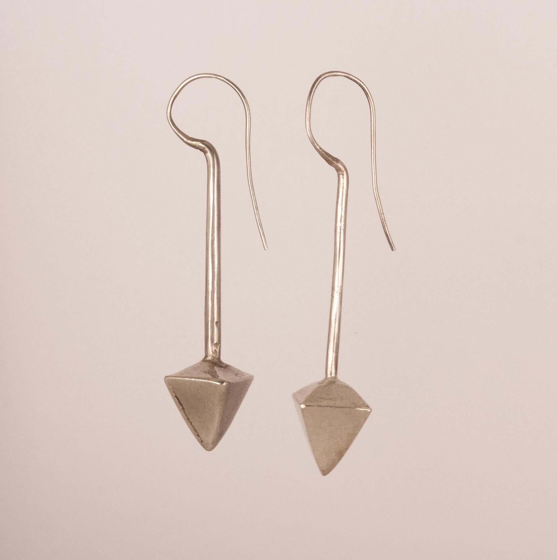 Tribal silver earrings with a pyramid design from north India, circa 1940. Despite their age and history, these silver earrings have a modern architectural appeal as well as a beautiful silver tone. The fixed wires are a bit thicker than today's