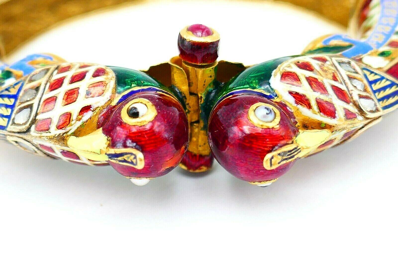 A colorful Indian bangle bracelet made of 22k yellow gold (tested), features hand painted enamel, rose cut diamond and cabochon ruby. Has a screw-in closure. 
Measurements: the inner circumference is 6.25