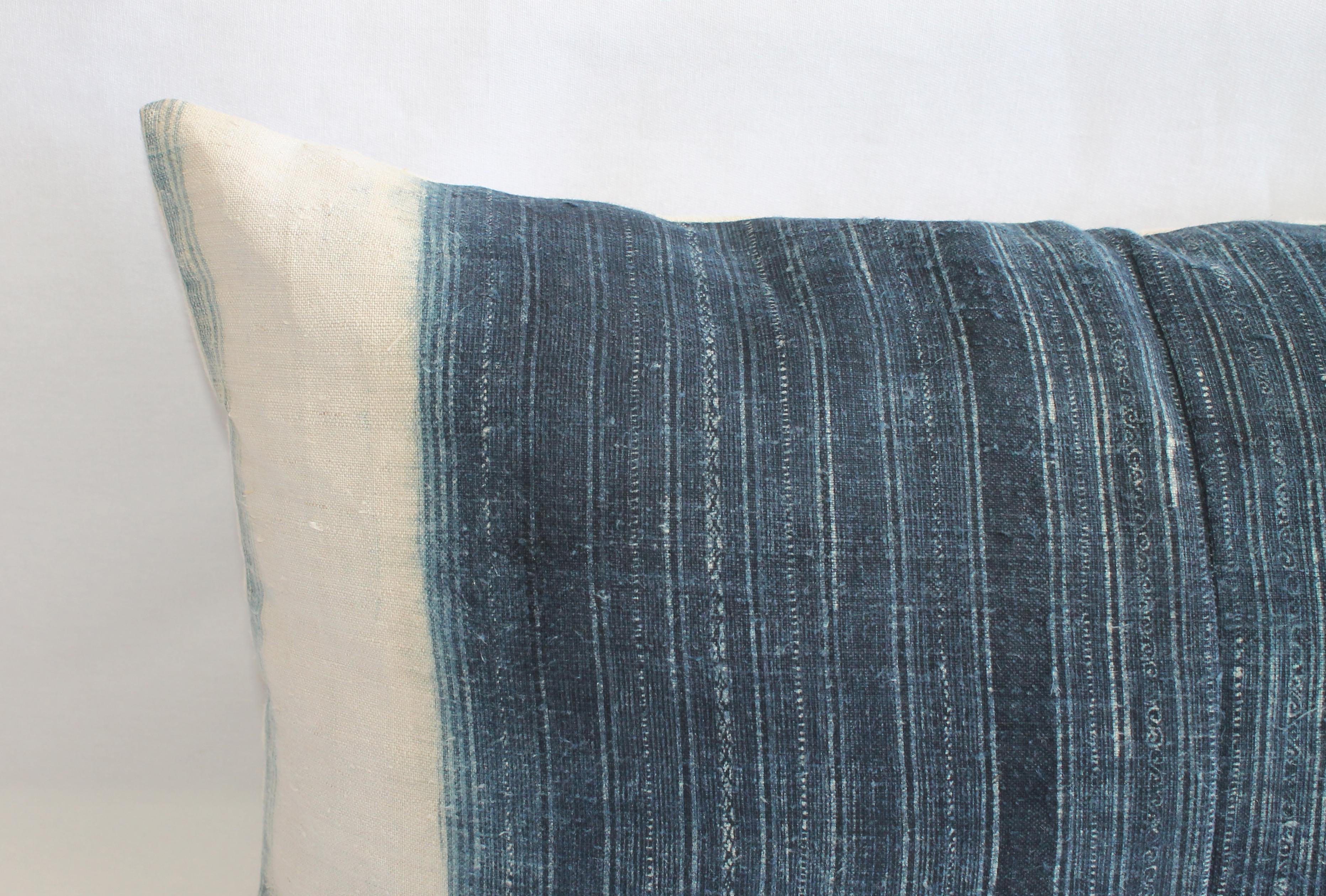 Vintage vertical indigo blue and white batik style pillow, with zipper closure. Back is in a natural antique French linen. Pillow is darkest in the center and then fades out to an off-white. Main colors are indigo blue, off-white, medium blue, and