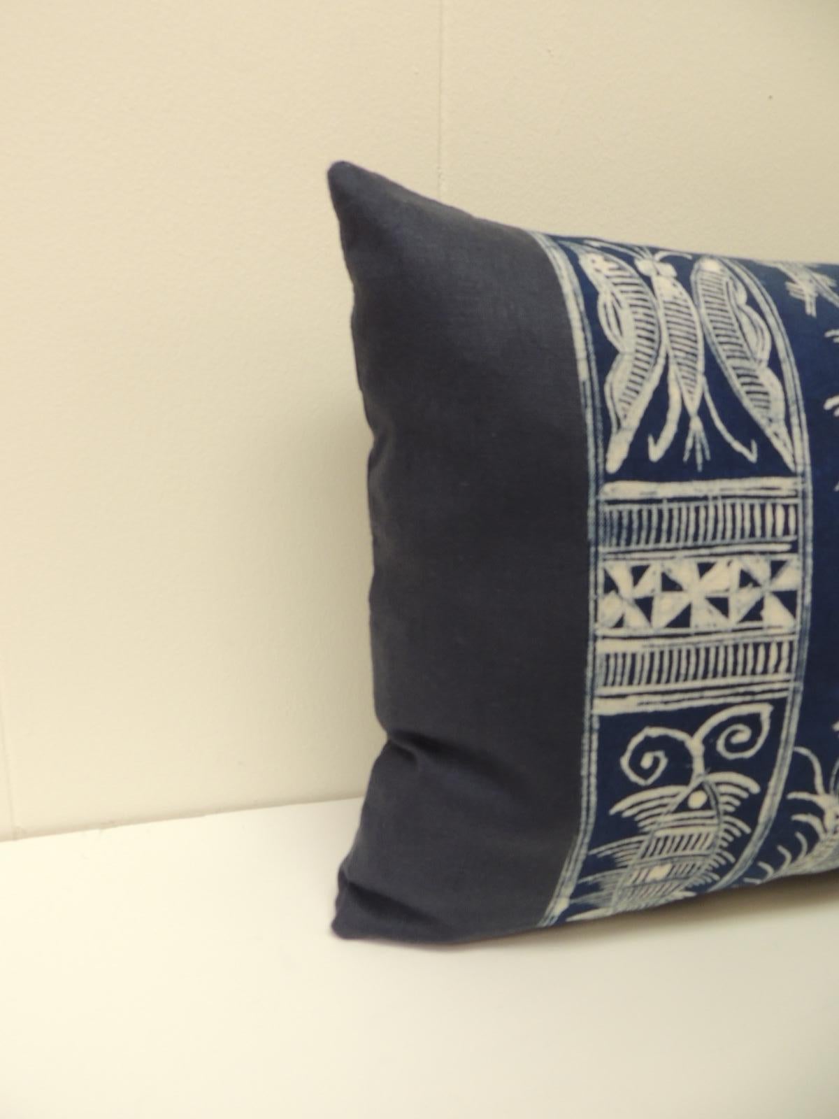 Vintage indigo and white hand blocked artisanal Batik textile lumbar decorative pillow with a
 motif depicting stylized paisleys. Vintage indigo and white Batik textile framed with a dark 
blue linen; same as backings. Elegant boho-chic
