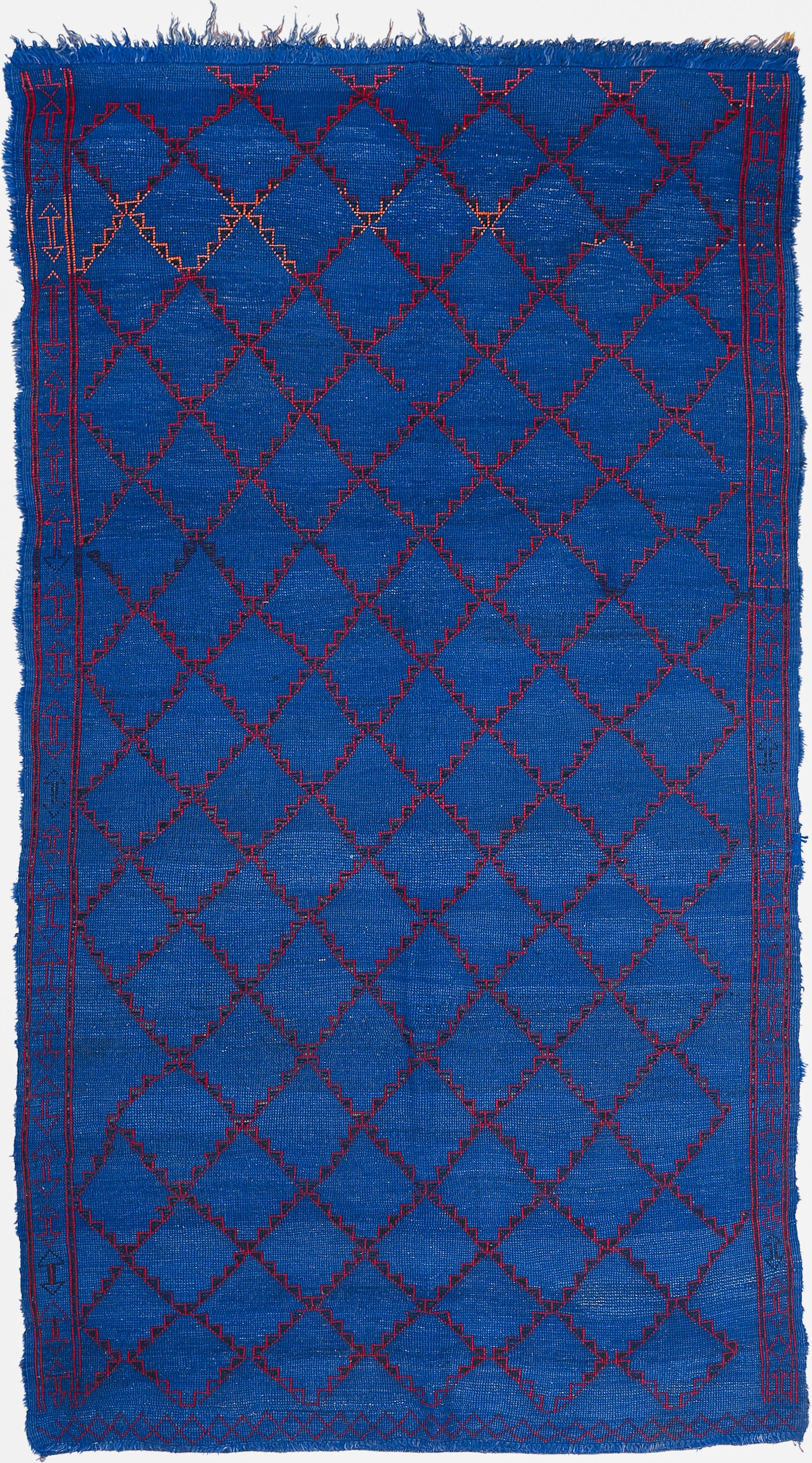 An authentic old Berber rug from the Middle Atlas Mountains, home of the Beni Mguild tribal confederacy, who are known to weave the best quality wool carpets of Morocco. Characterized by an all-over pattern of diamonds, the red offers a perfect