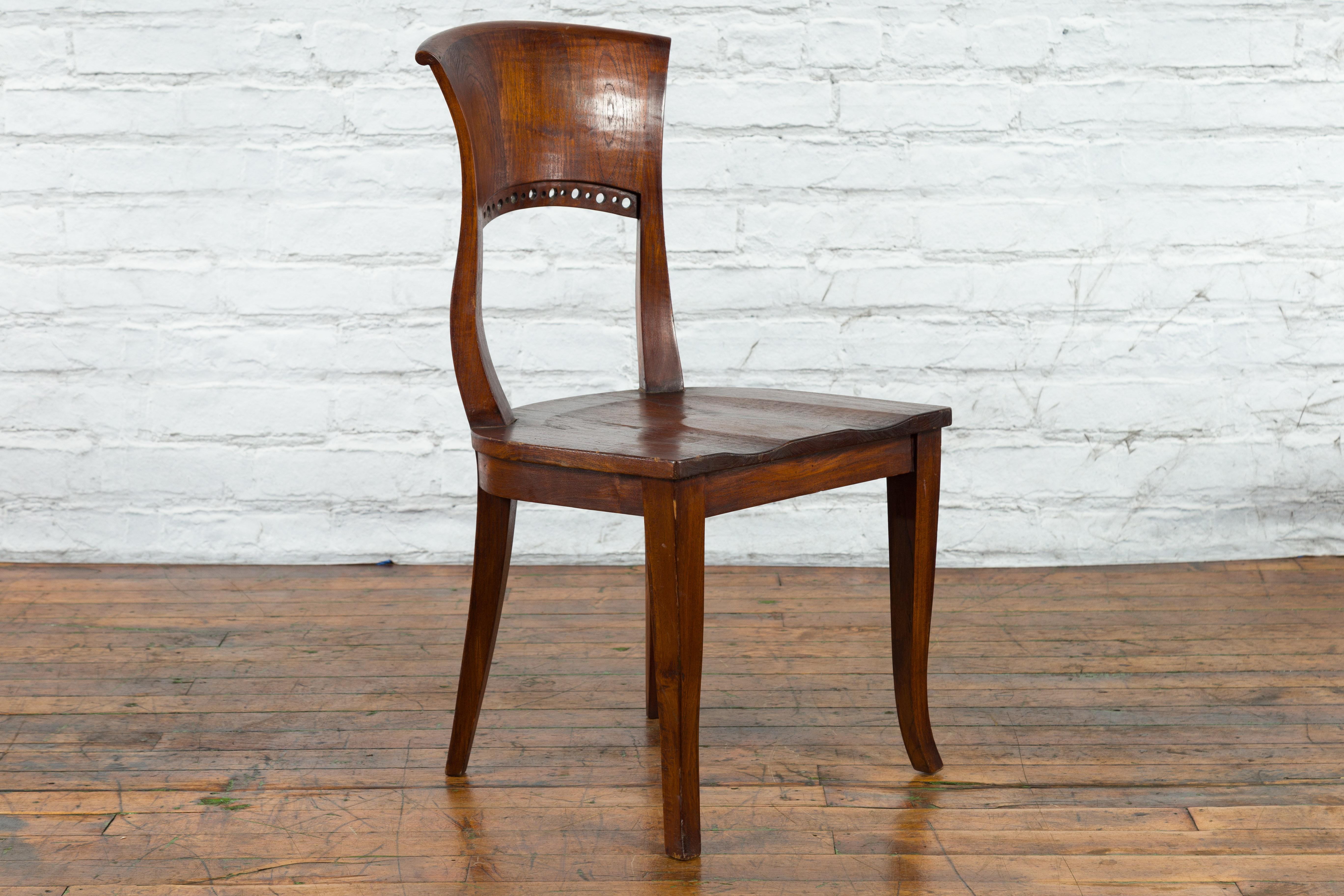 Vintage Indonesia Wooden Accent Chair with Pierced Circular Motifs Curving Back In Good Condition For Sale In Yonkers, NY