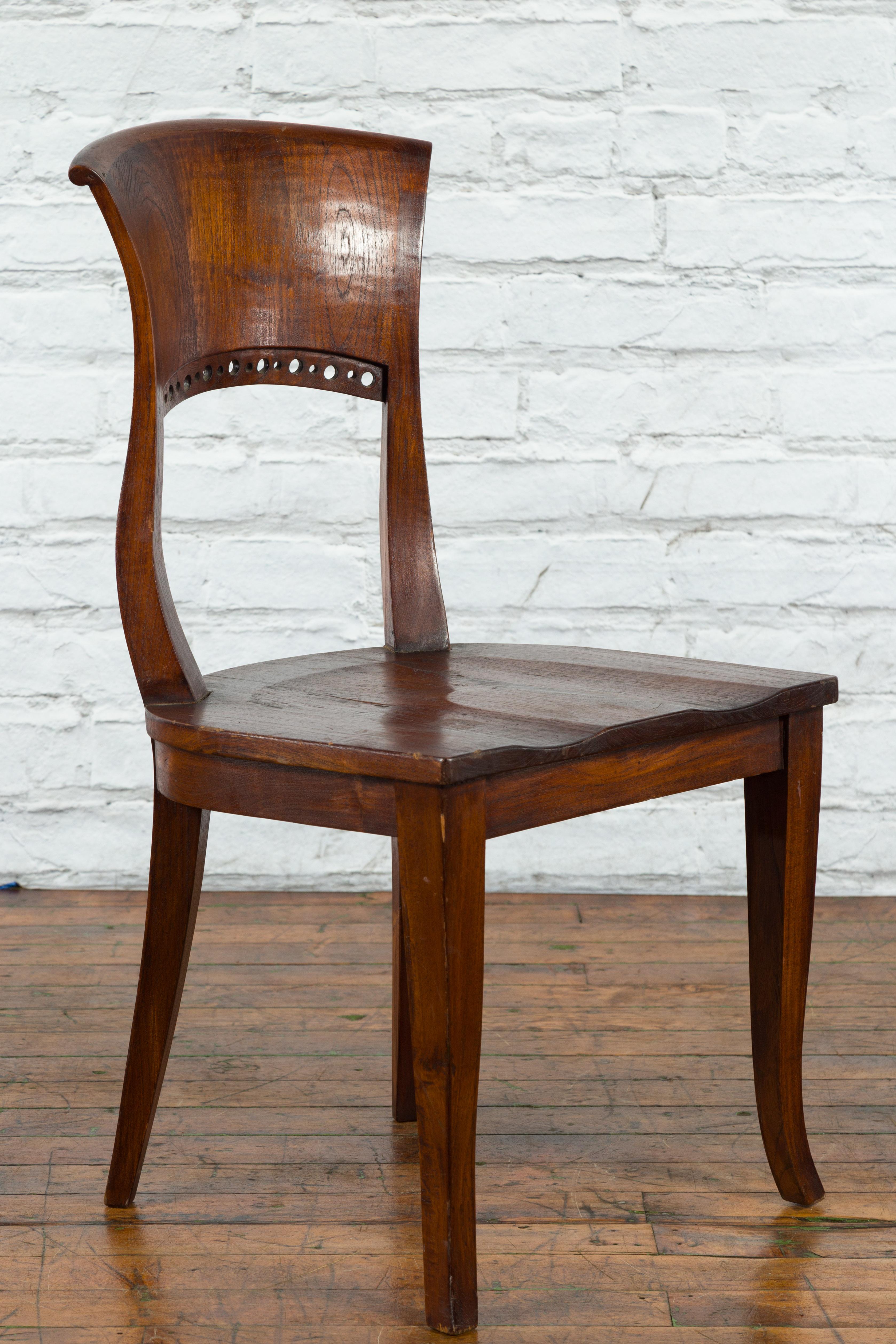 20th Century Vintage Indonesia Wooden Accent Chair with Pierced Circular Motifs Curving Back For Sale