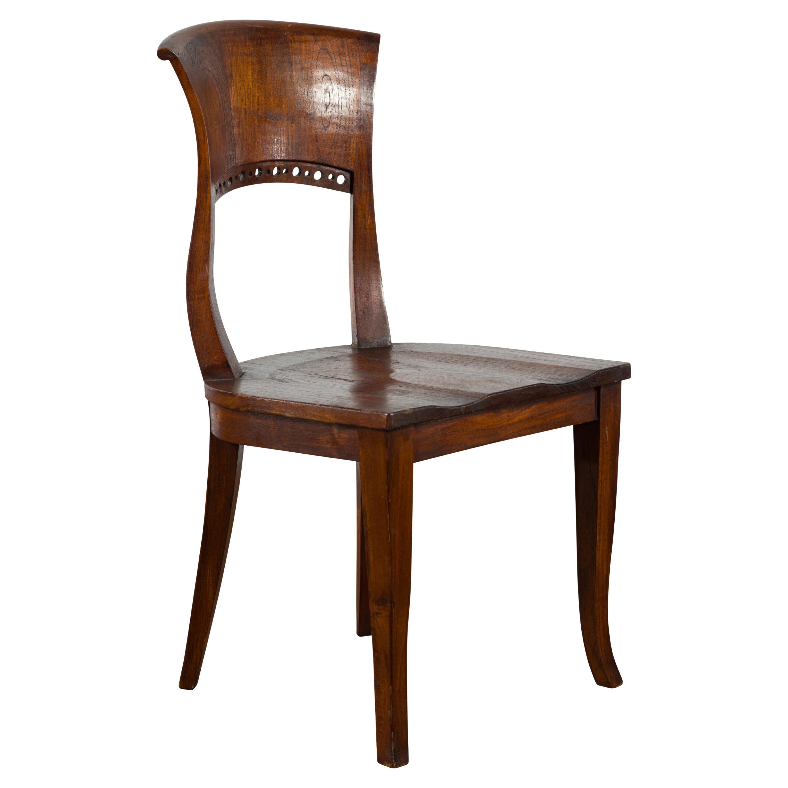 Vintage Indonesia Wooden Accent Chair with Pierced Circular Motifs Curving Back For Sale