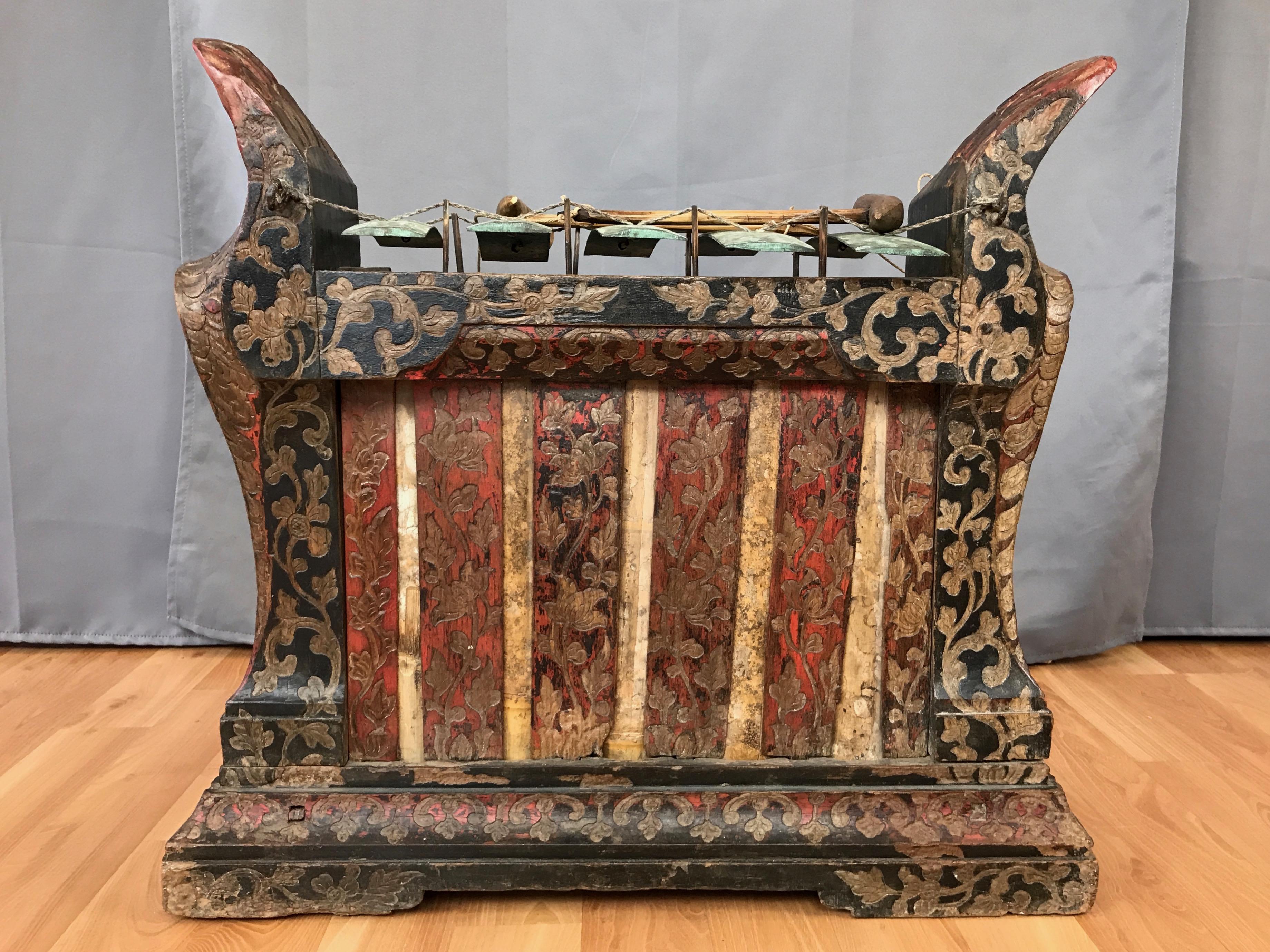 An enchanting 1940s Indonesian carved wood and bronze gambang gangsa with mallets.

A gambang gangsa is a metallophone—similar to a xylophone, but with tuned metal bars (or gongs) rather than wood—used in Balinese and Javanese traditional Gamelan