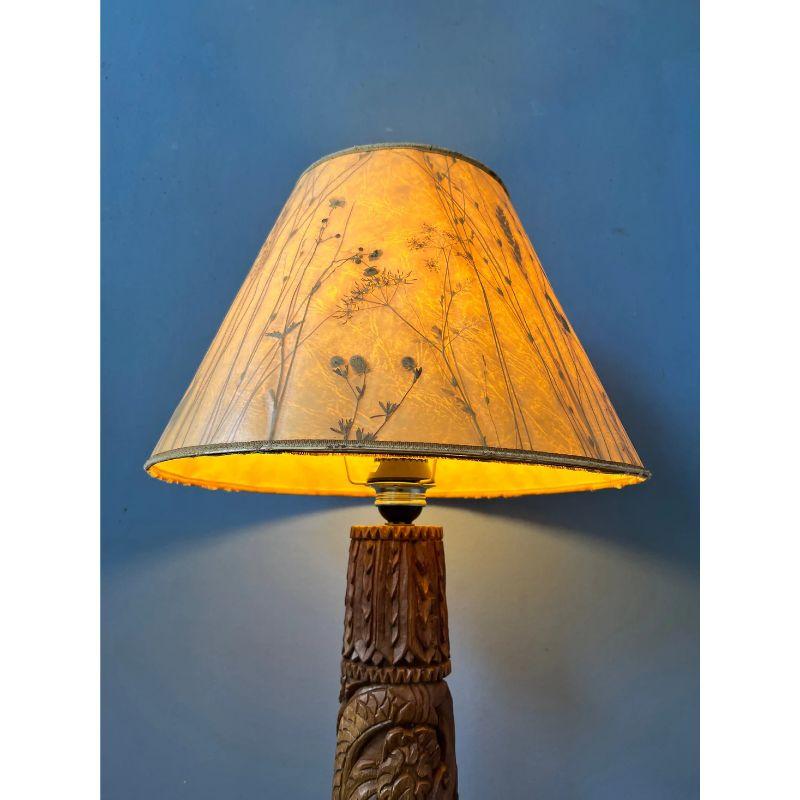 One of a kind hand carved wooden floor lamp from Indonesia. The lamp requires one E27 lightbulb and currently has an EU-plug.

Dimensions:
Diameter shade: 25 cm
Height: 71 cm

Condition: Good. The wooden base is in great shape, but shade has