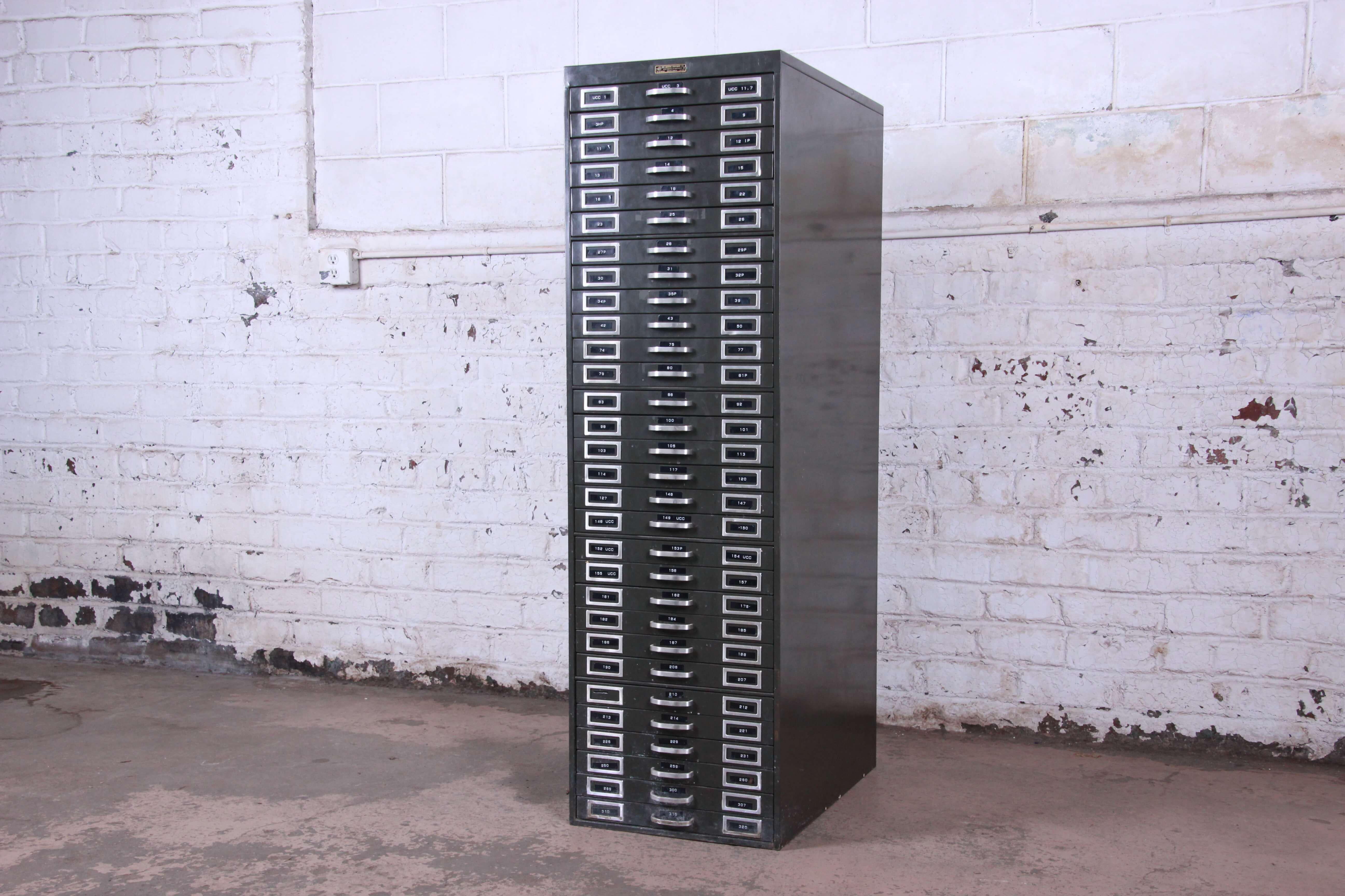 Offering a unique vintage industrial 30-drawer metal flat file from the Monroe Furniture Co in Chicago. The cabinet is made from a heavy gauge steel and offer thirty smooth sliding drawers for ample storage and organization. The cabinet is in good