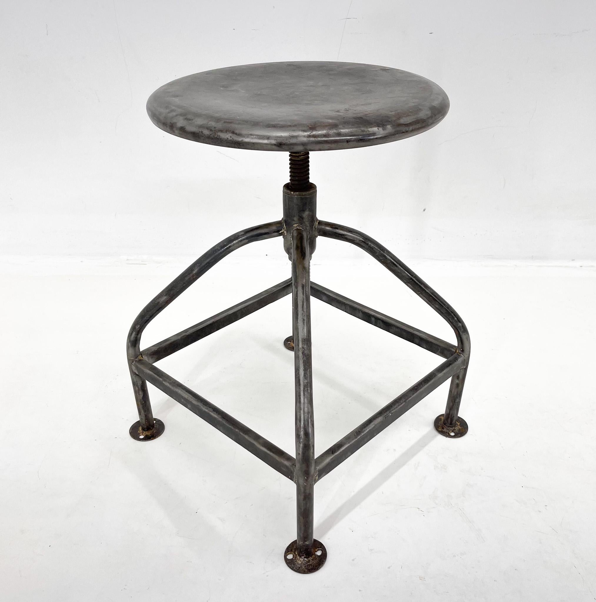 Vintage industrail stool with adjustable hight. Made of brushed steel. Widest point at the bottom is 39 cm. Maximum hight can be 60 cm and minimum hight is 45 cm.