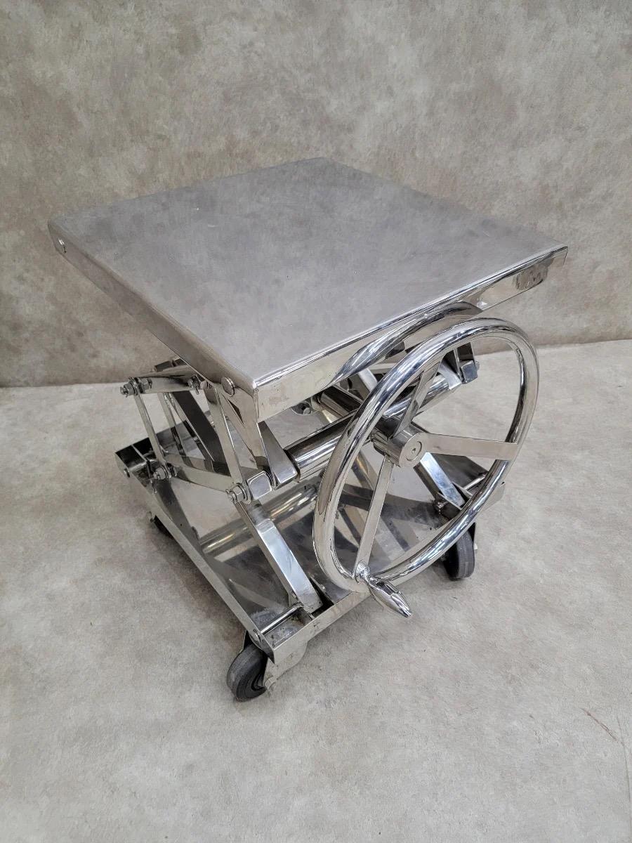 Vintage Industrial Adjustable Chrome Scissor Lift Side Table

Unique adjustable manual scissor lift printer stand/side table on wheels comes with some Chicago history. The piece was salvaged from a local funeral home and is ready for your