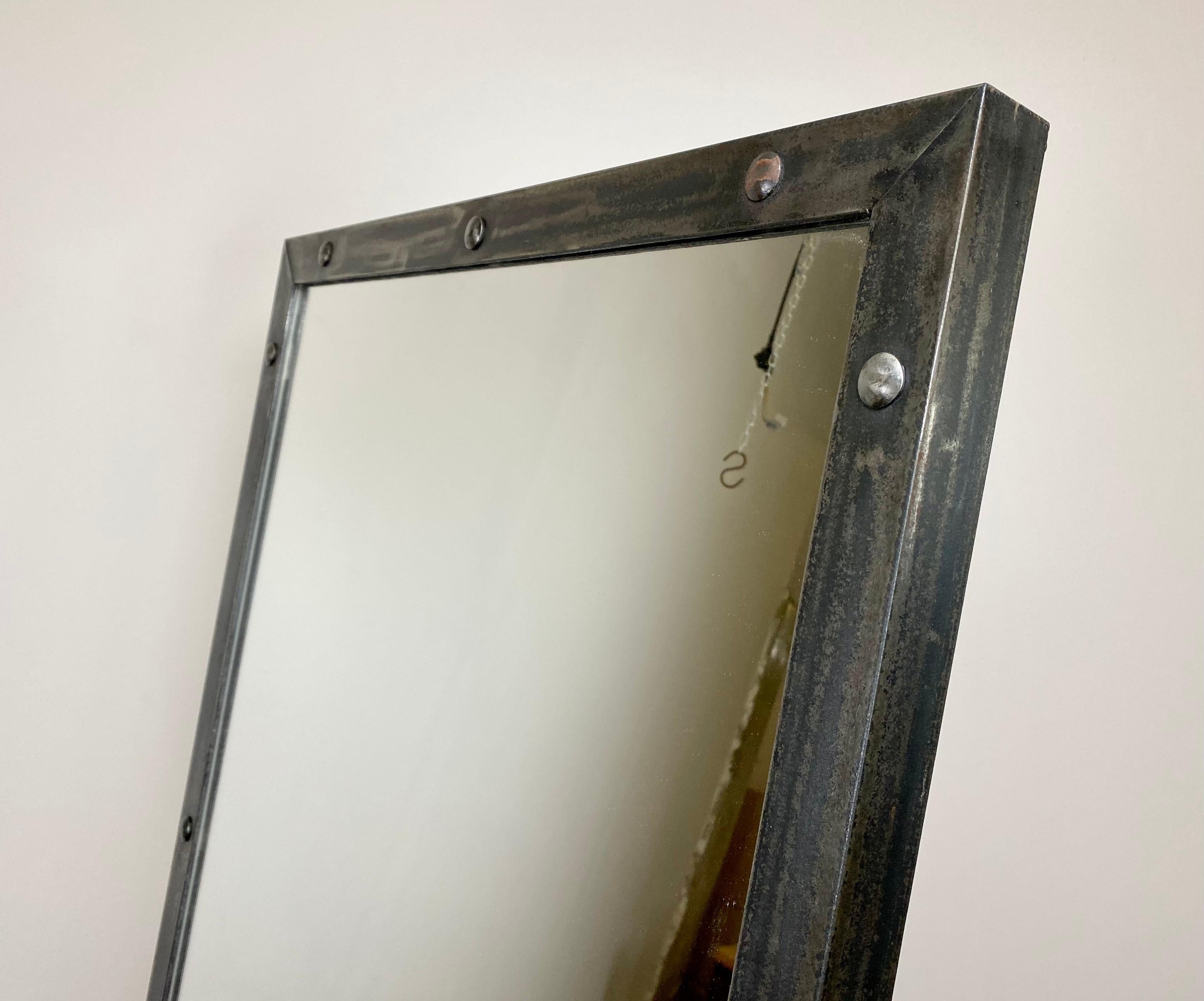 Industrial mirror with adjustable angle. Iron frame filled with a mirror mounted on cast iron legs. The weight of the mirror is 85 kg.