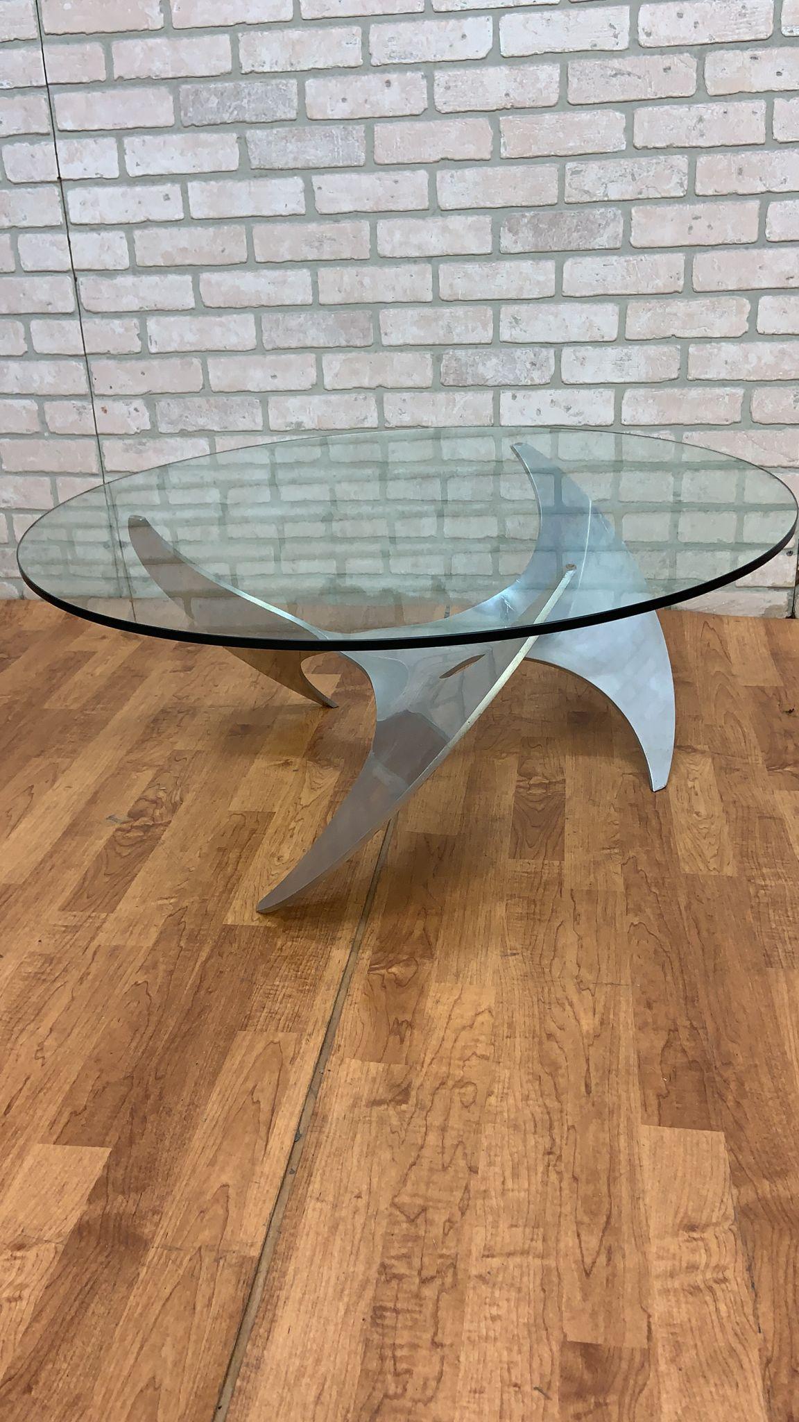 Vintage Industrial Aluminum Propeller Coffee Table by Knut Hesterberg

Classic mid century modern German propeller coffee table by Knut Hesterberg for Ronald Schmitt featuring a sculptural polished aluminum propeller-form base with a glass top.