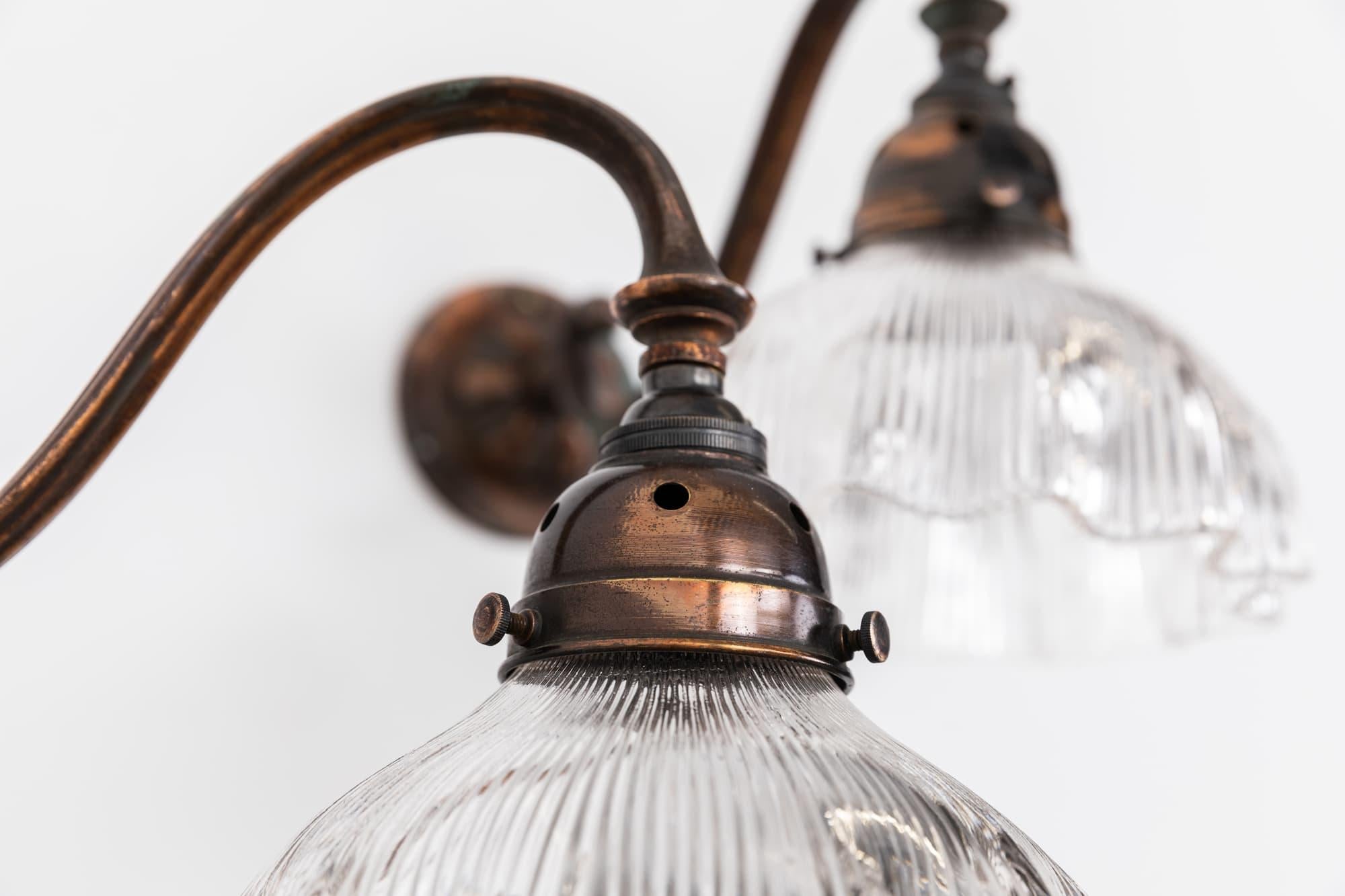 

A pair of oxy-copper plated swan neck wall lights made in England by GEC. c.1930

Brass construction with beautifully tarnished copper plate. Prismatic glass lamp shades and original copper galleries. Priced as a pair.

Rewired to connect to