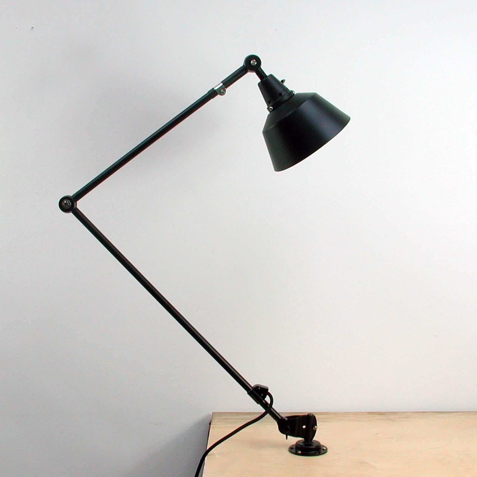 This vintage articulated work lamp was originally designed by Curt Fisher for Midgard / Industriewerke Auma. To improve lighting in industrial workplaces Midgard developed a range of flexibly adjustable lights from the early 1920s, such as this