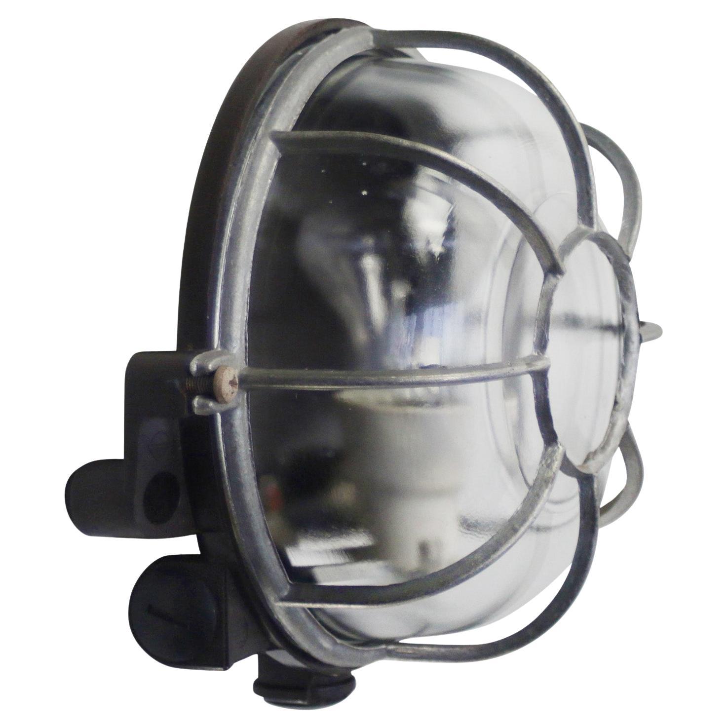 Industrial sconce, wall lamp.
Bakelite back, clear glass
Aluminium cage

Weight 1.0 kg / 2.2 lb

Priced per individual item. All lamps have been made suitable by international standards for incandescent light bulbs, energy-efficient and LED bulbs.