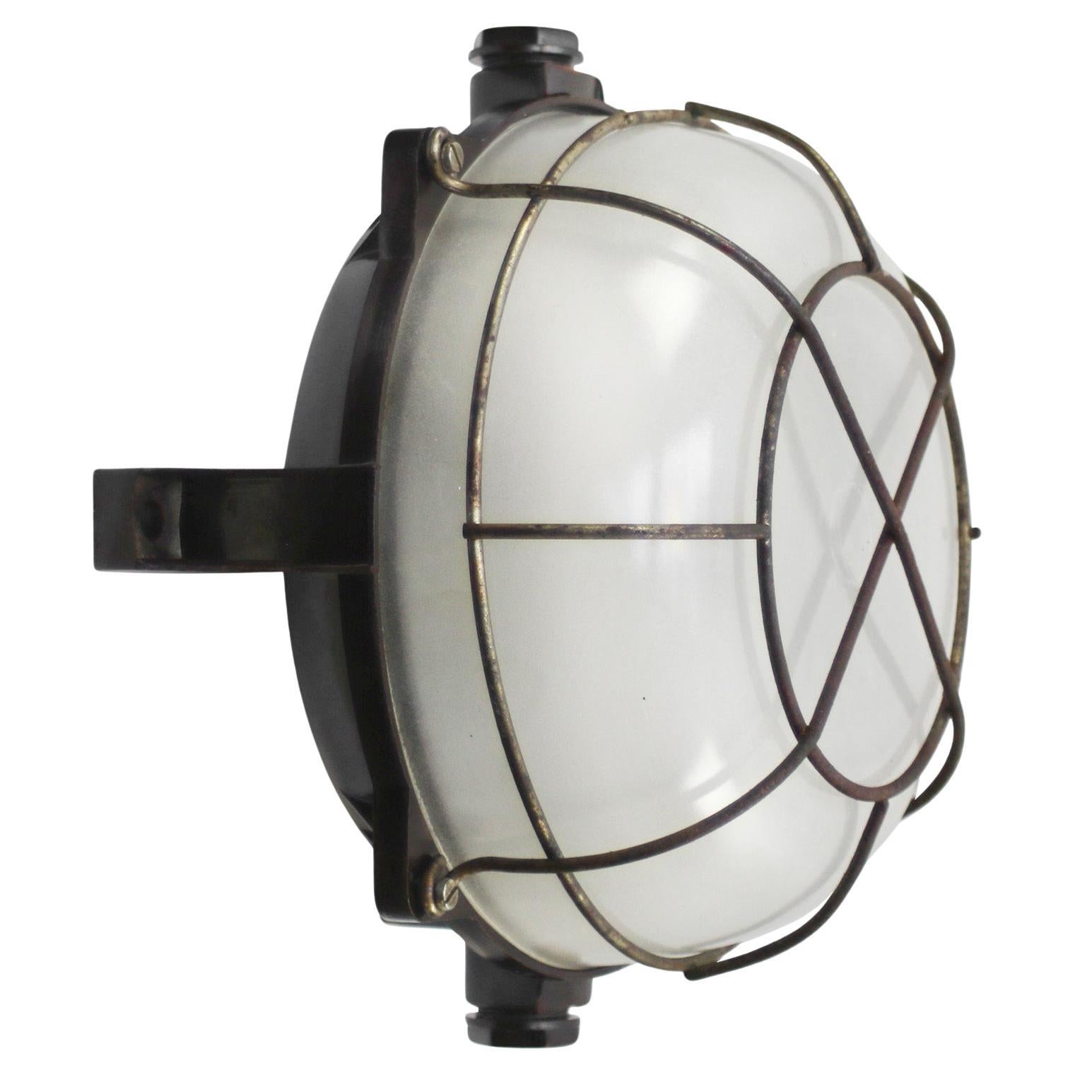 Industrial wall and ceiling scone
Bakelite back, milk frosted glass
metal cage

Weight: 2.20 kg / 4.9 lb

Priced per individual item. All lamps have been made suitable by international standards for incandescent light bulbs, energy-efficient and LED
