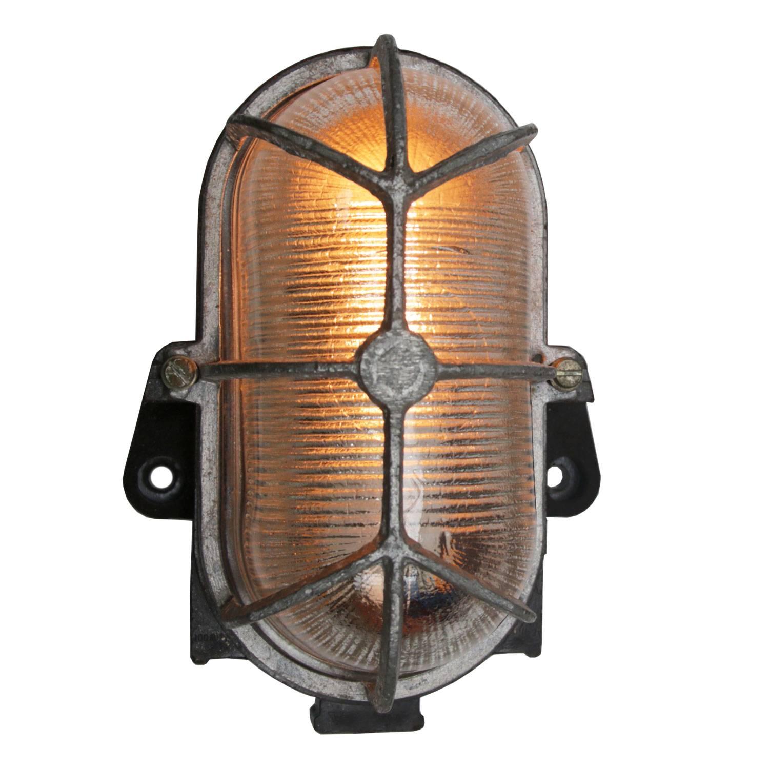 Industrial wall and ceiling scone. Bakelite back. 
Holophane striped glass.
Aluminum frame.

Weight: 0.8 kg / 1.8 lb

Priced individual item. All lamps have been made suitable by international standards for incandescent light bulbs,