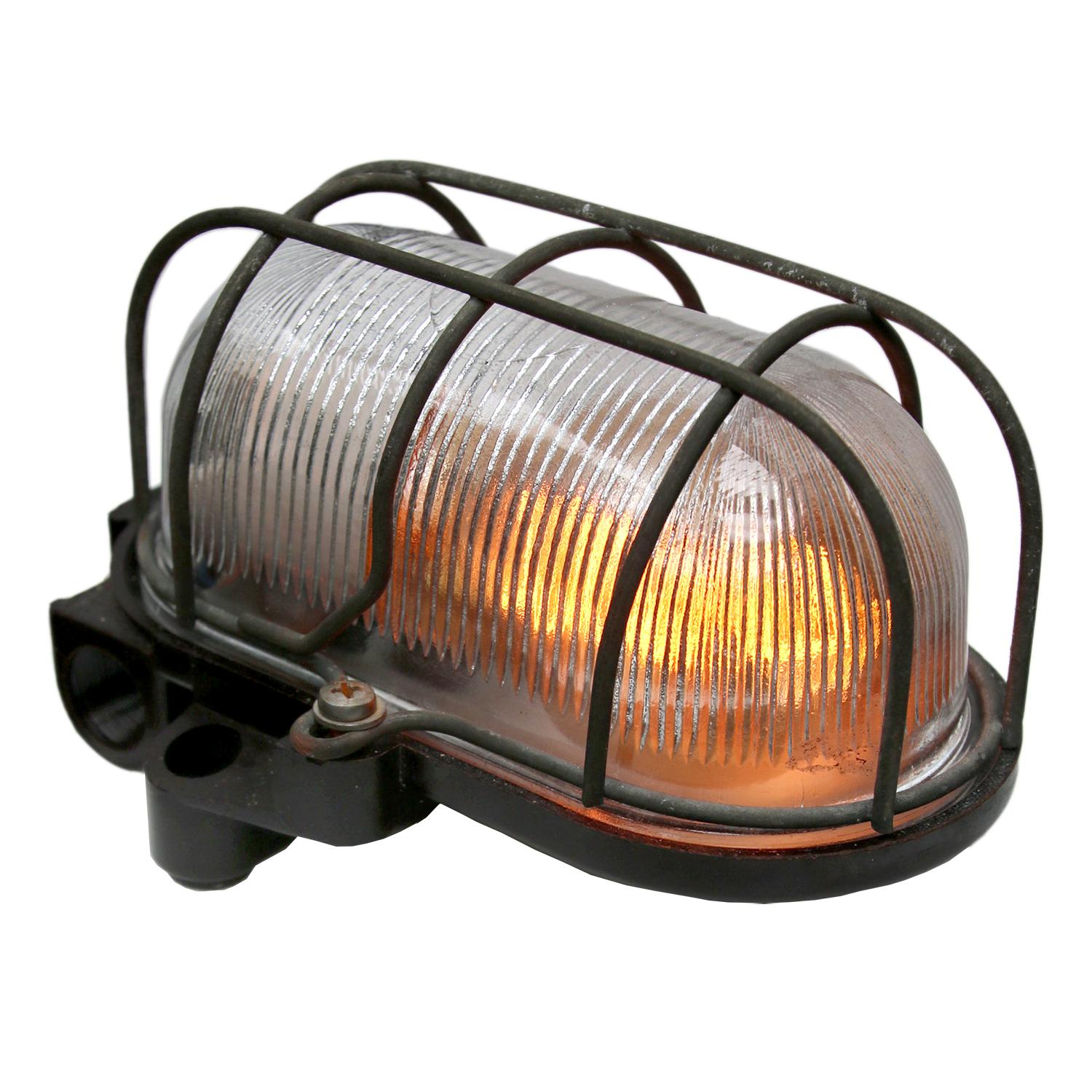 Industrial wall and ceiling scone. Bakelite back. Holophane striped glass.
Metal wire frame.

Weight: 0.8 kg / 1.8 lb

Priced per individual item. All lamps have been made suitable by international standards for incandescent light bulbs,