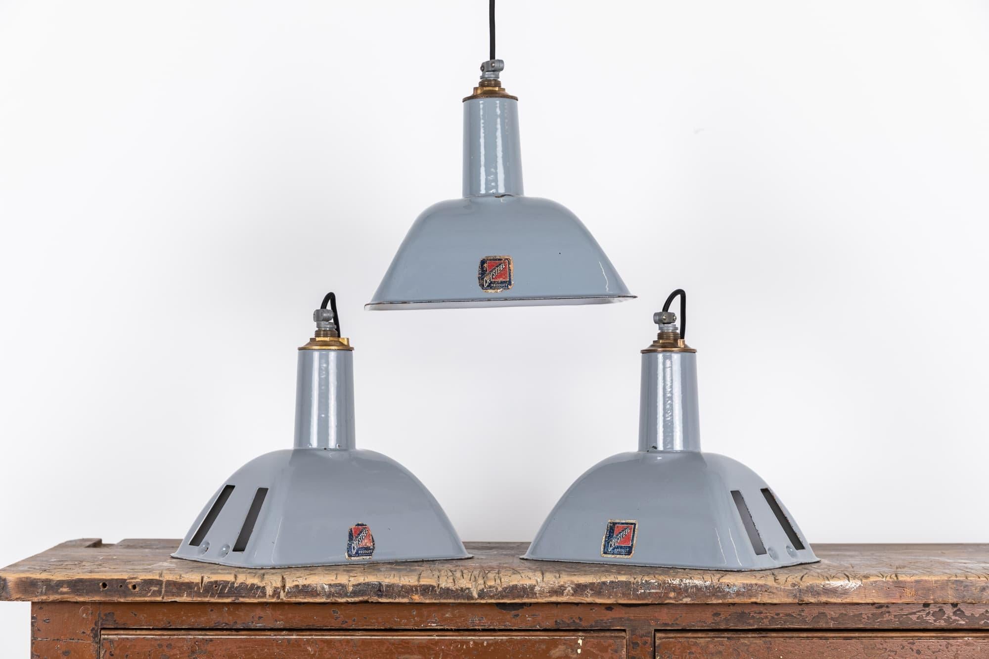

Grey vitreous enameled pendant lights by renowned industrial manufactures Benjamin Electric. c.1930

In a smaller size and unusual rectangle shape, surviving in amazing original condition, with very little wear to the enamel and remnants of the