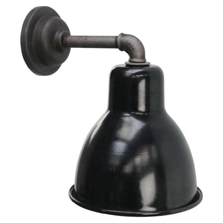 Factory wall light.
Black enamel shade, cast iron arm and wall plate

Diameter cast iron wall piece: 10 cm, 2 holes to secure

Weight: 1.60 kg / 3.5 lb

Priced per individual item. All lamps have been made suitable by international standards