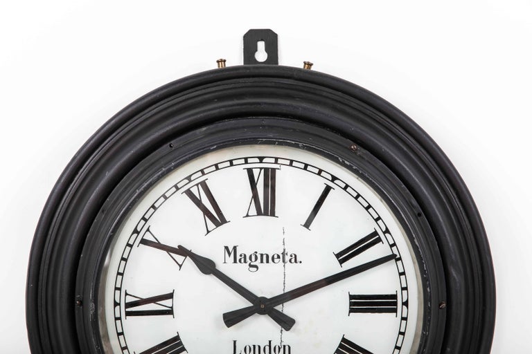 Imposing British railway clock made in England by well known clock makers Magneta Electric. c.1920

Likely once used in a railway setting, this clock has been left in as found, original condition - just cleaned and preserved. The clock surround is