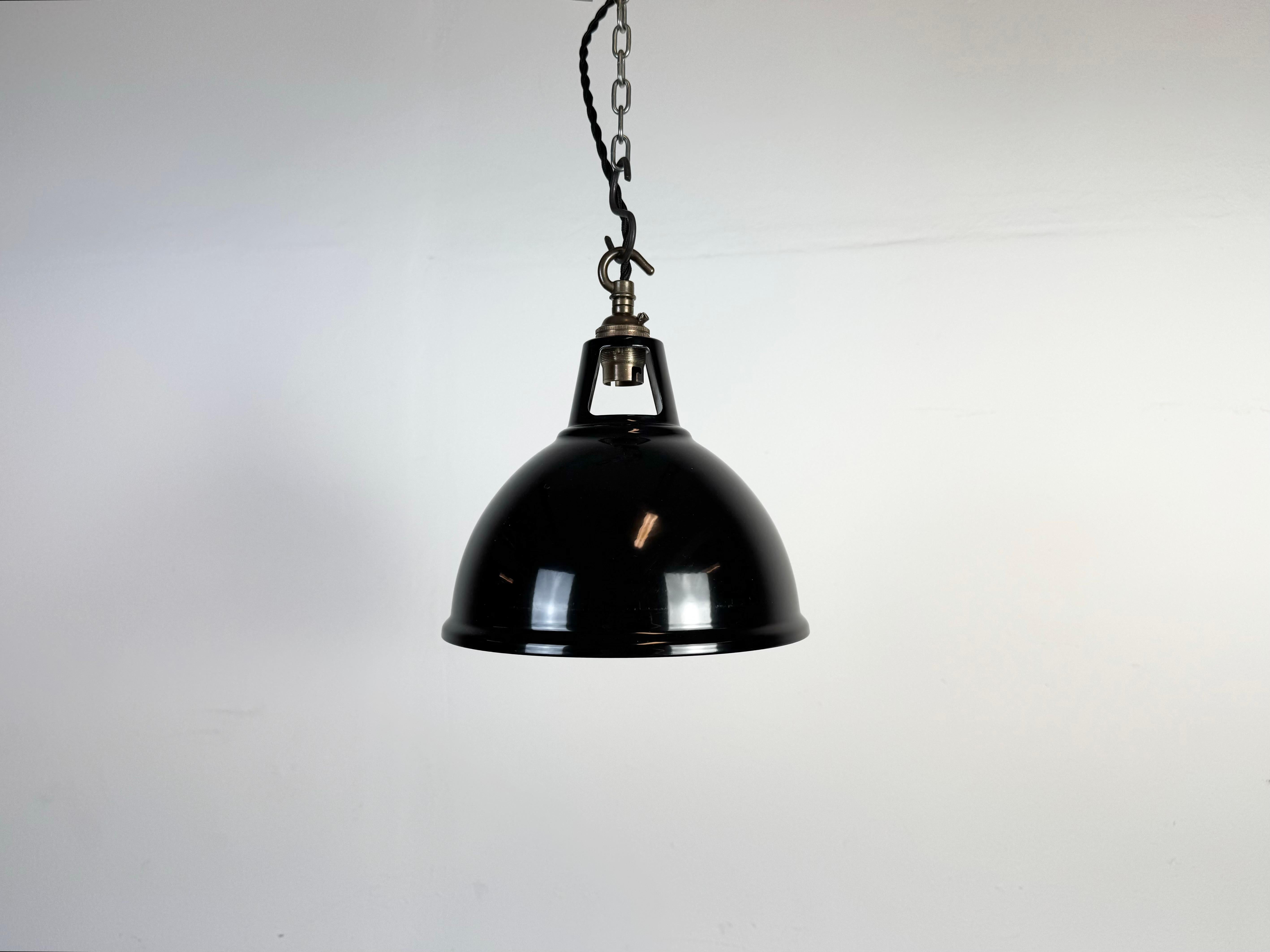 Vintage black painted pendant light in industrial style made in United Kingdom between 2000-2010. White painted inside the shade. Brass top. The socket requires  B22 light bulbs. New wire. The weight of the lamp is 0,3 kg.The diameter of the lamp is