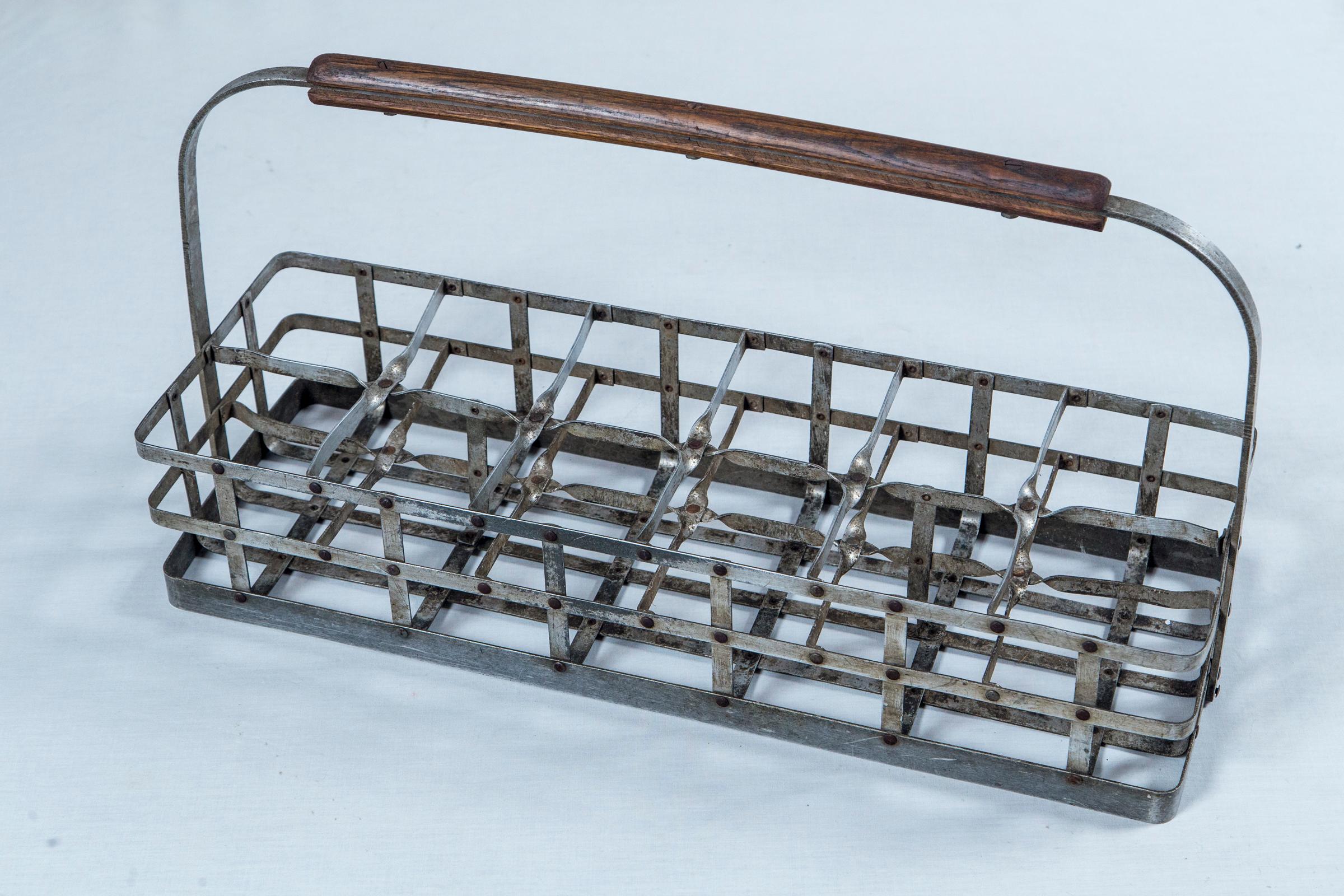 Vintage Industrial bottle carrier, circa 1950. Aluminum construction with wood handle. Used to hold sample bottles in a commercial/factory setting.