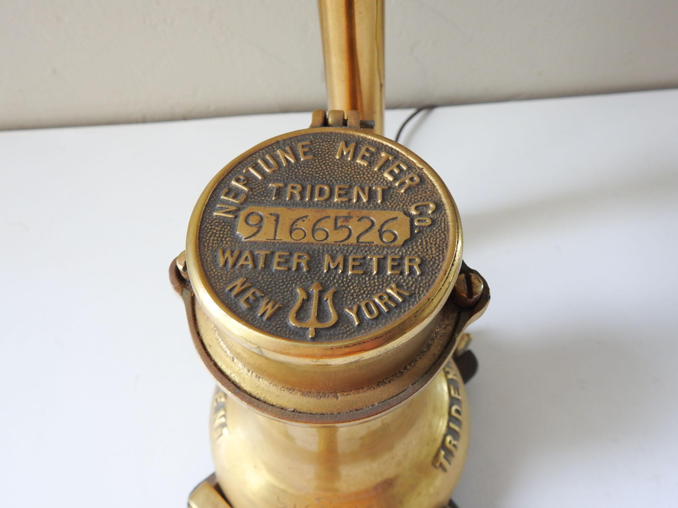 Table lamp made from antique brass water meter and pipe.  New York Neptune Trident Meter, standard light bulb, comes with Edison style blub.  Has a rather short cord about 40