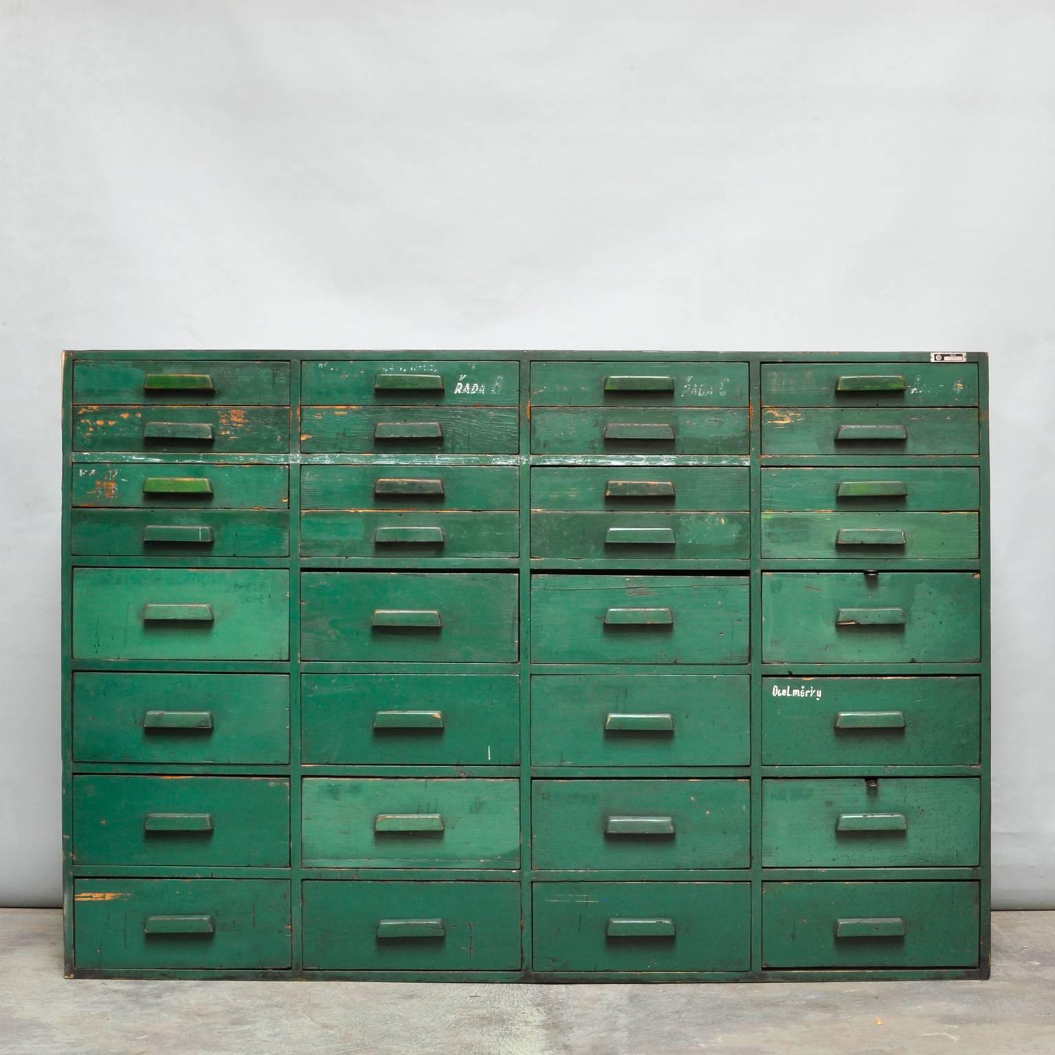 Industrial cabinet from the factory of car manufacturer Tatia from the Czech Republic. Made of wood with 32 drawers. Made in the 1950s.