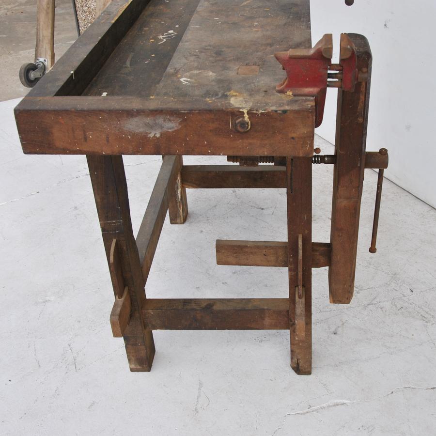 Vintage industrial work bench 

Turn of the century 2 tier work bench with metal vices marked Reed MFG Company and a recessed tray where tools were stored. 

  