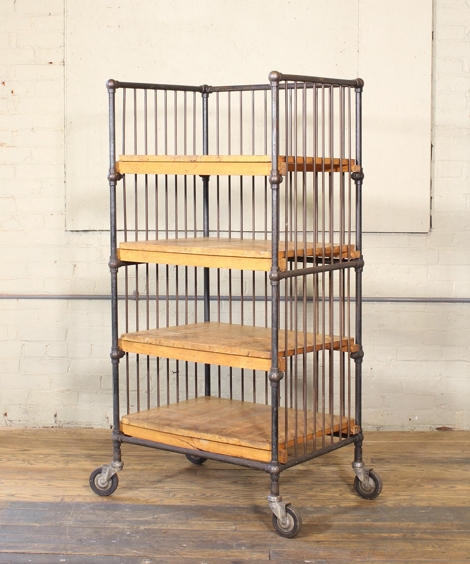 Authentic vintage four-shelf printers bindery rolling bar cart with bubble joints and swivel castors. Overall dimensions: 27 1/2