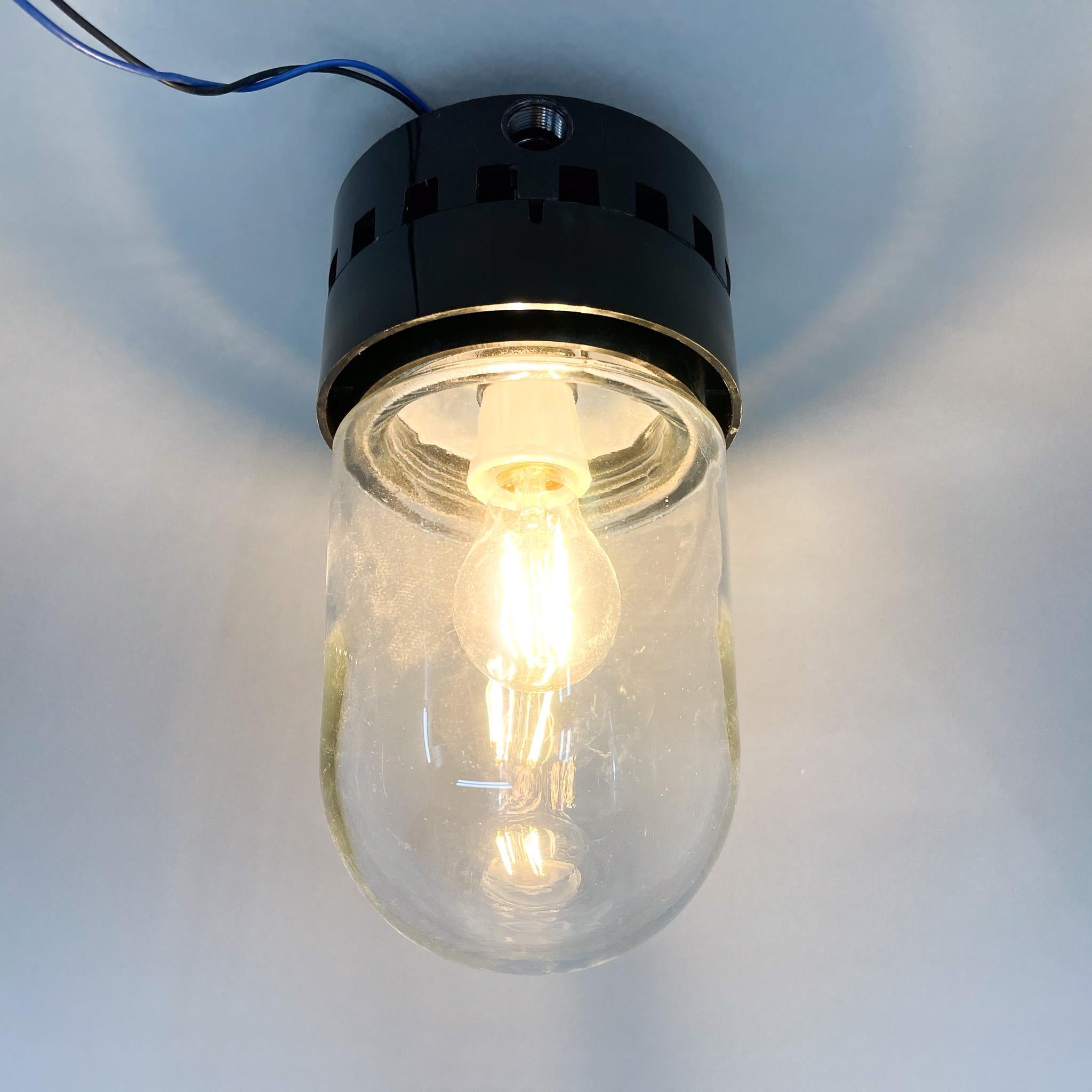 Industrial ceiling or wall light made of bakelite and clear glass. New wiring. Four items available upon request.