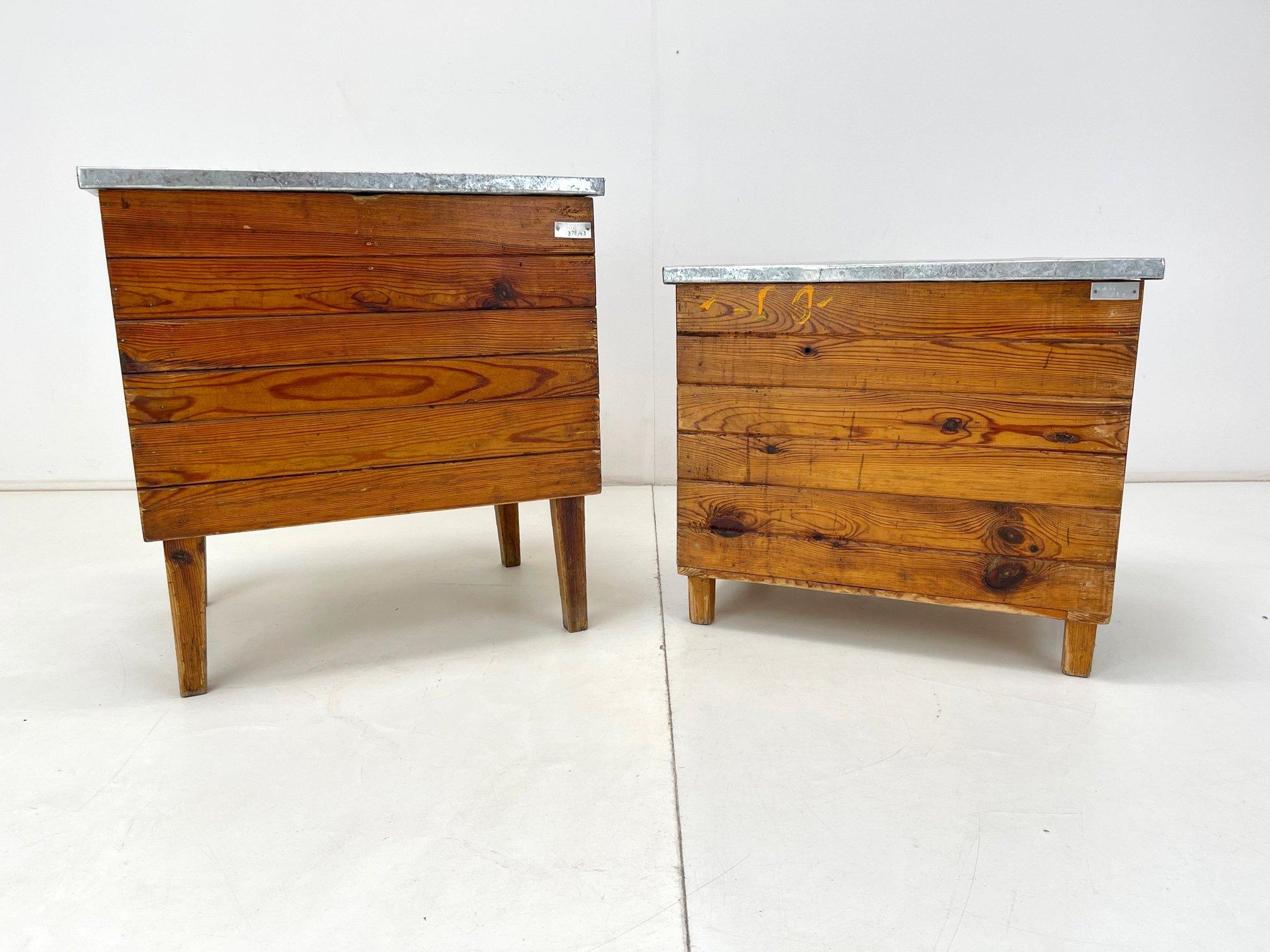 Vintage industrial wooden chest with metal top in original condition. 
Can be used i various ways. 
The taller box is 63 cm high, 60 cm wide and 43 cm deep. The smaller box is 52 cm high, the width and depth is the same as the taller one.