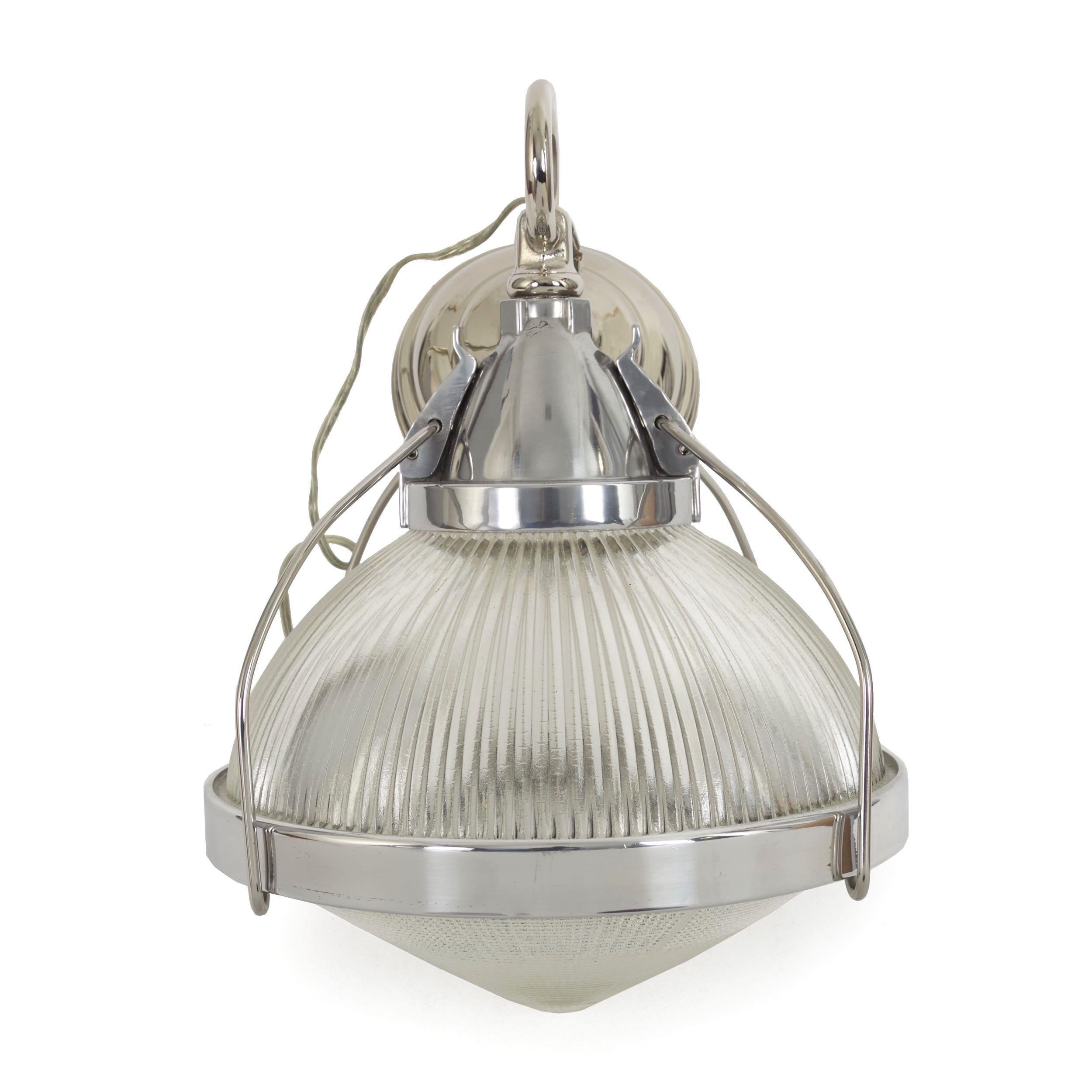 A sleek and interesting vintage industrial pendant light, it features a gorgeous high-polish chrome against polished aluminum around the molded holophane glass. All hardware is of very high quality and the lamp has been thoughtfully designed: cast