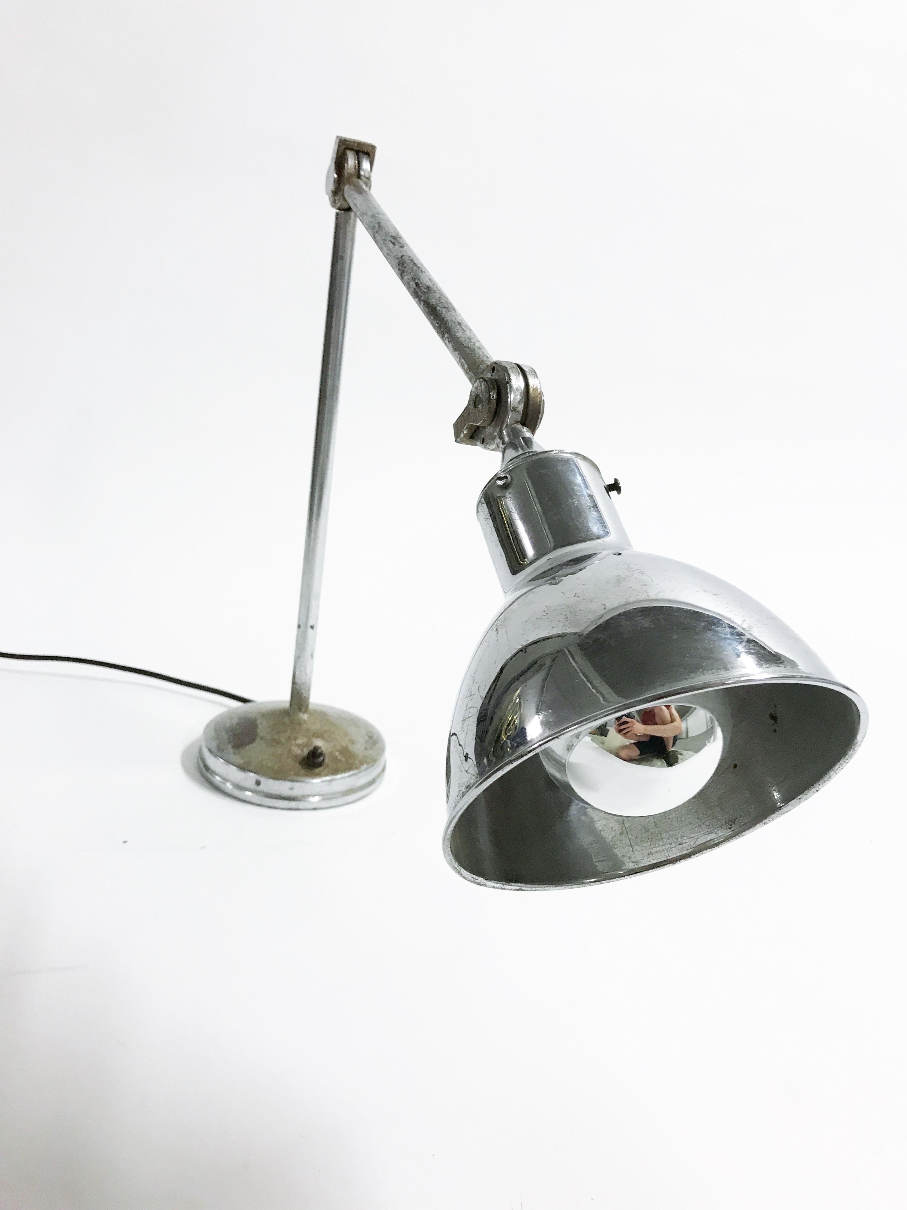 Large chrome machinist or work light.

The lamp has an articulated arm and lamp shade, making it very adjustable.

This was used in old factories on work benches etc.

AGI was a small Belgium based company producing industrial lighting in the