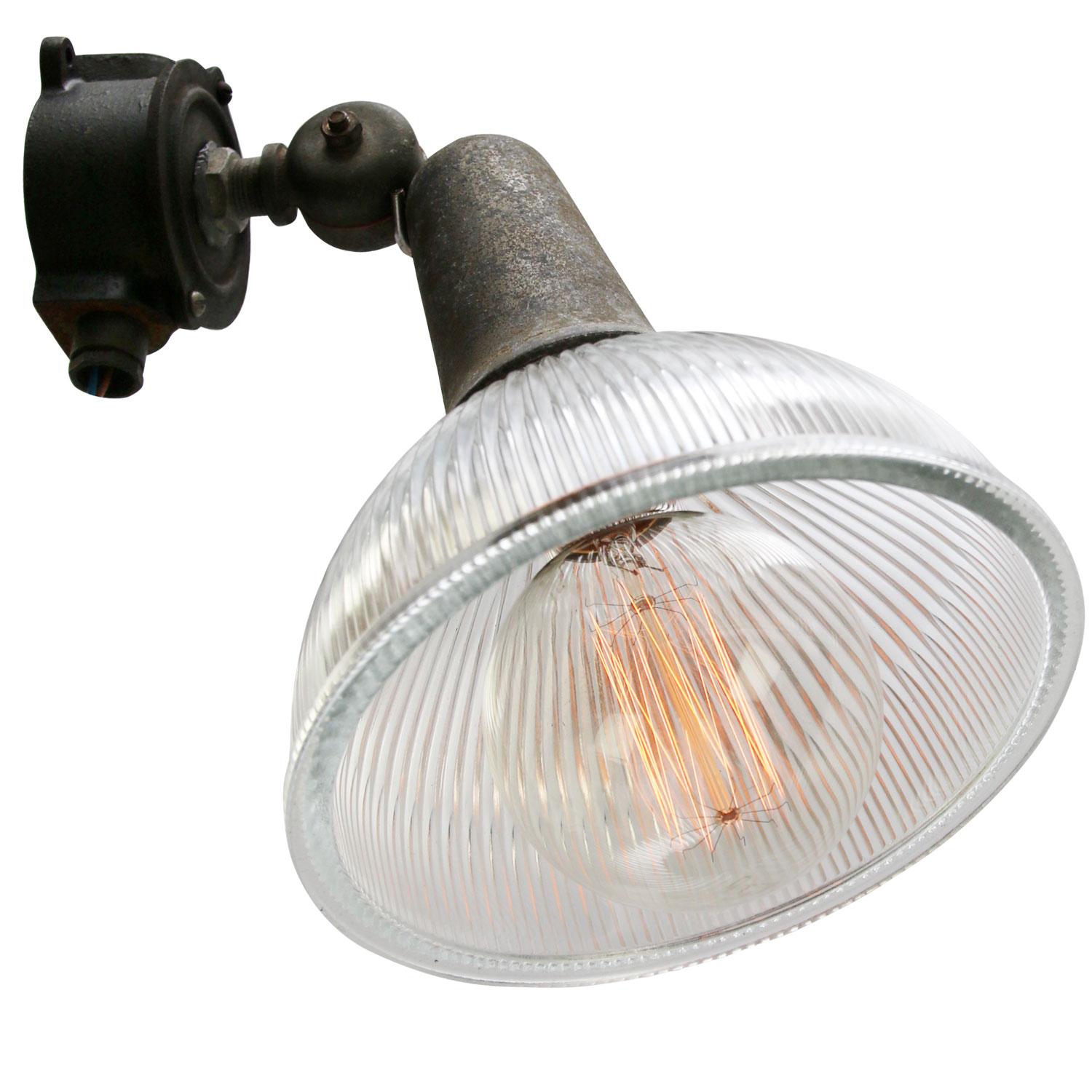 industrial wall lamp / scone
Clear striped Holophane glass shade.
Cast iron wall mount with cast aluminum neck

Weight: 1.40 kg / 3.1 lb

Priced per individual item. All lamps have been made suitable by international standards for incandescent