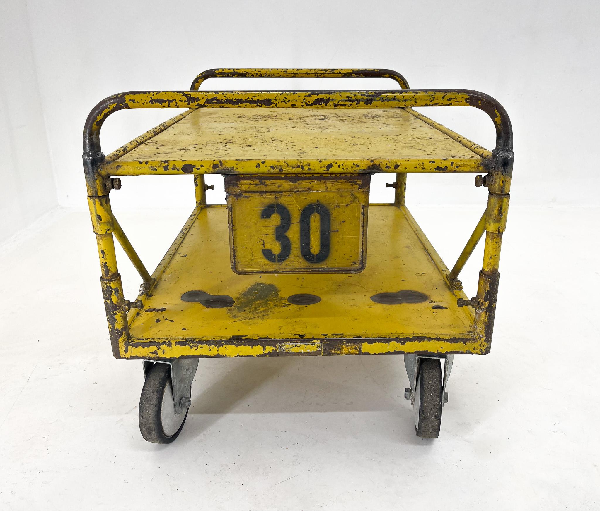 Industrial trolley with original yellow paint. Salvaged from a jewellery factory in former Czechoslovakia. Can be used as an original coffee table, side table or whatever your fancy. An original piece that will brighten up any interior.