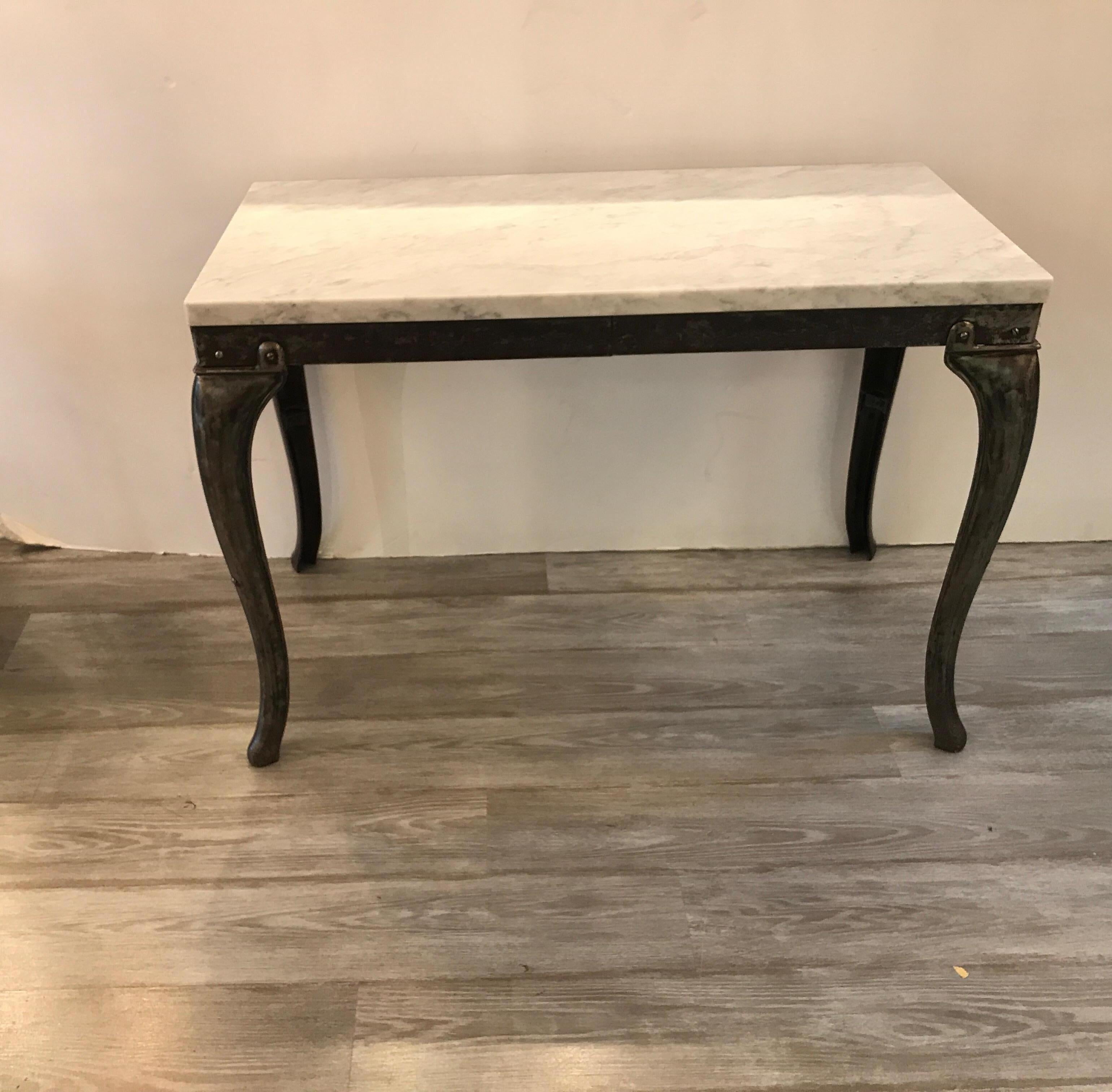 Unusual Industrial rectangular table with burnised steel base and marble-top. The tradition form with an Industrial flair in steel with and aged finish.