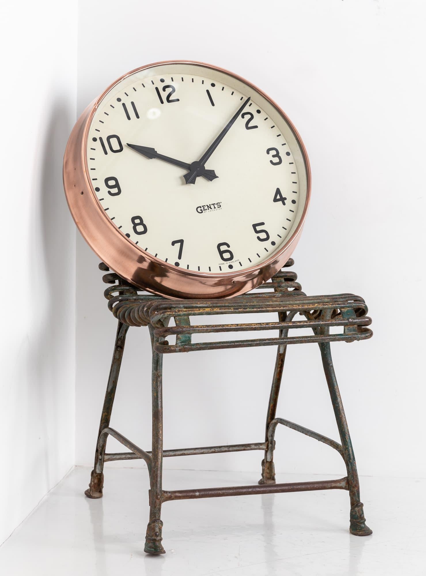 Beautiful example of a wall clock made in England by renowned electrical manufactures Gents of Leicester. c.1930

Casing has been stripped of paint to show the elegant copper beneath. Gents' arrowed hands running perfectly on the original 240v