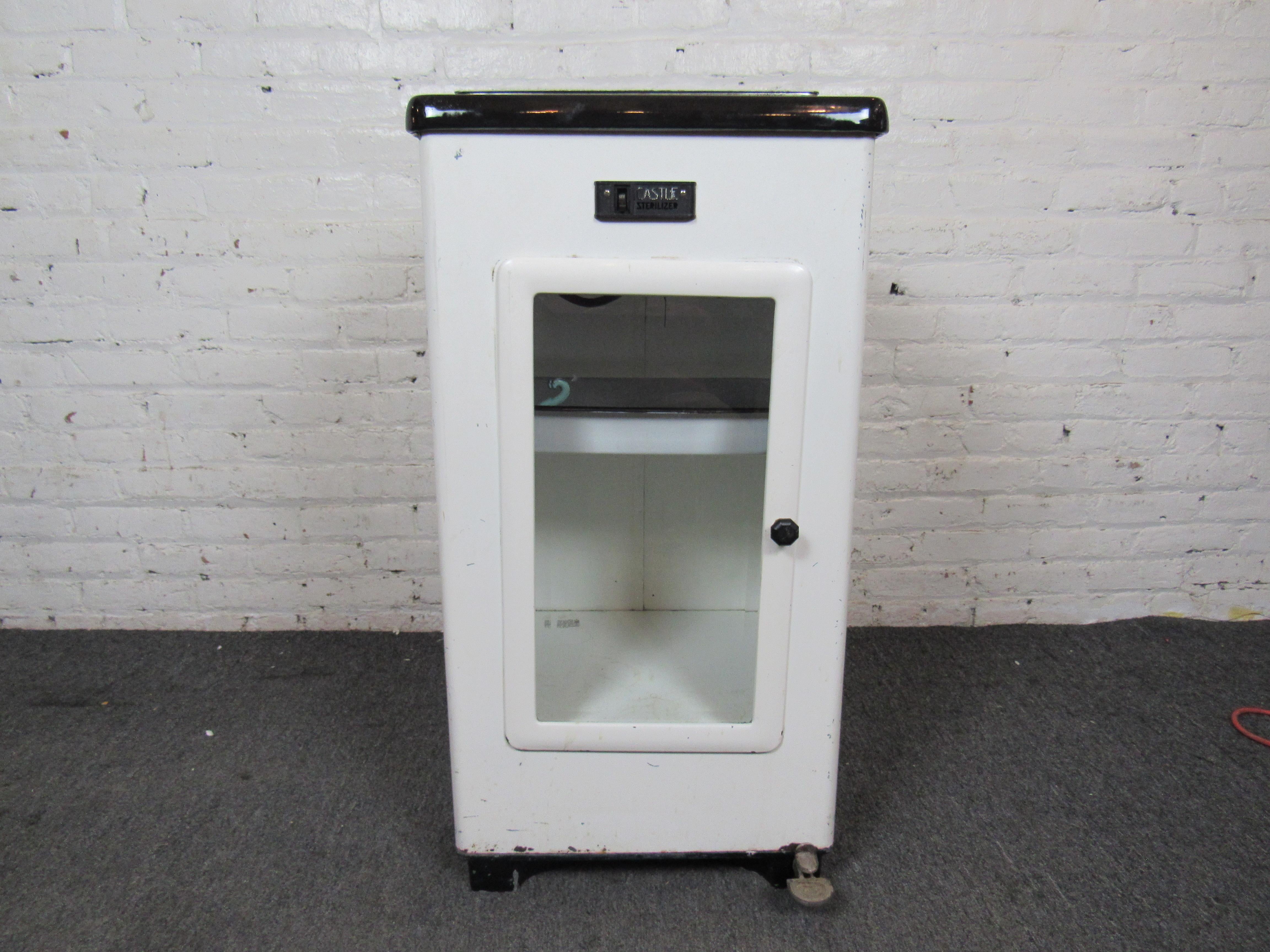 This mid-century dental storage cabinet shows off unique features like a built-in sterilizer operated by a foot pedal. An intriguing vintage cabinet that could be useful as a decorative item or display case. Please confirm item location with seller