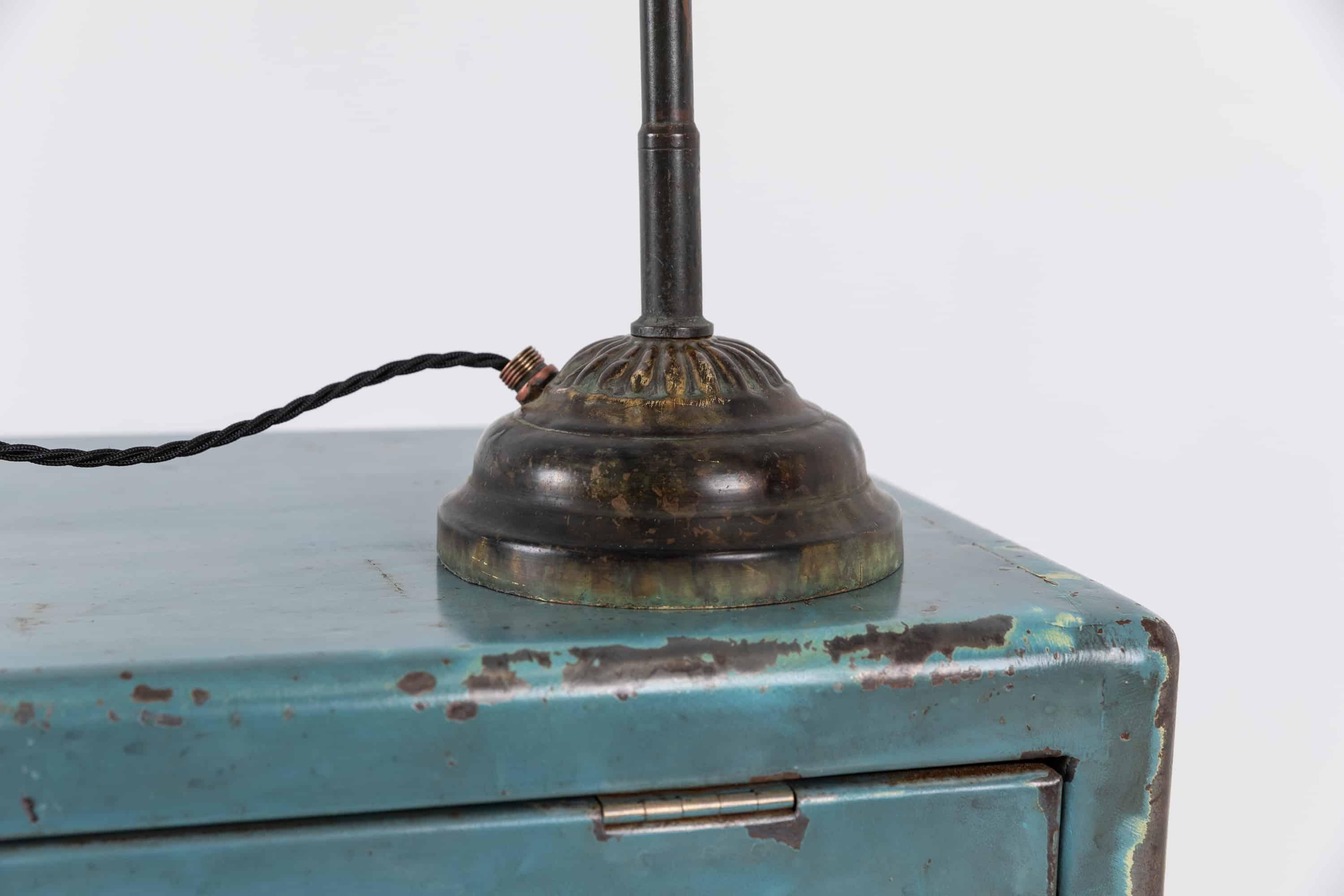 An elegant brass desk lamp by renowned English lighting company Dugdills. circa 1920

Rare early example made entirely of brass, featuring the 'rosettes' for tightening the joints and clam shell shade. Preserved in original condition showing the